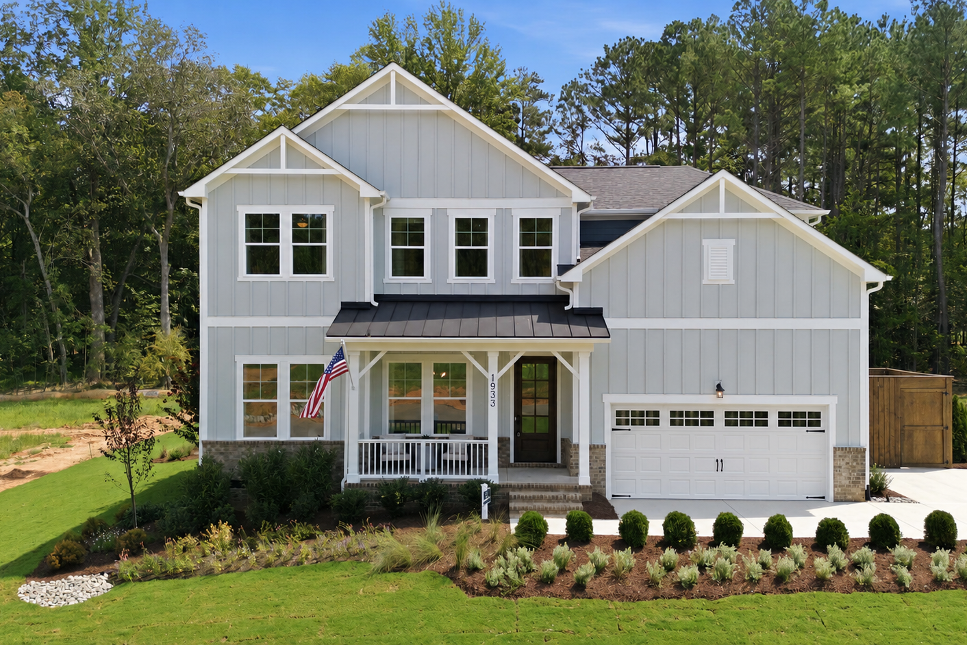 Modern farmhouse exterior at Rockport in Wake Forest, NC, built by Davidson Homes with a covered porch and two-car garage.