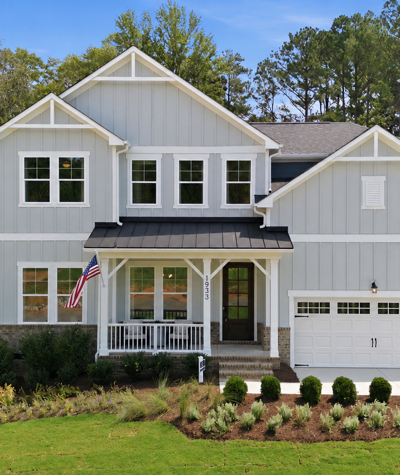 Davidson Homes exterior at Rockport in Wake Forest, NC featuring olive board and batten siding and two-car garage.