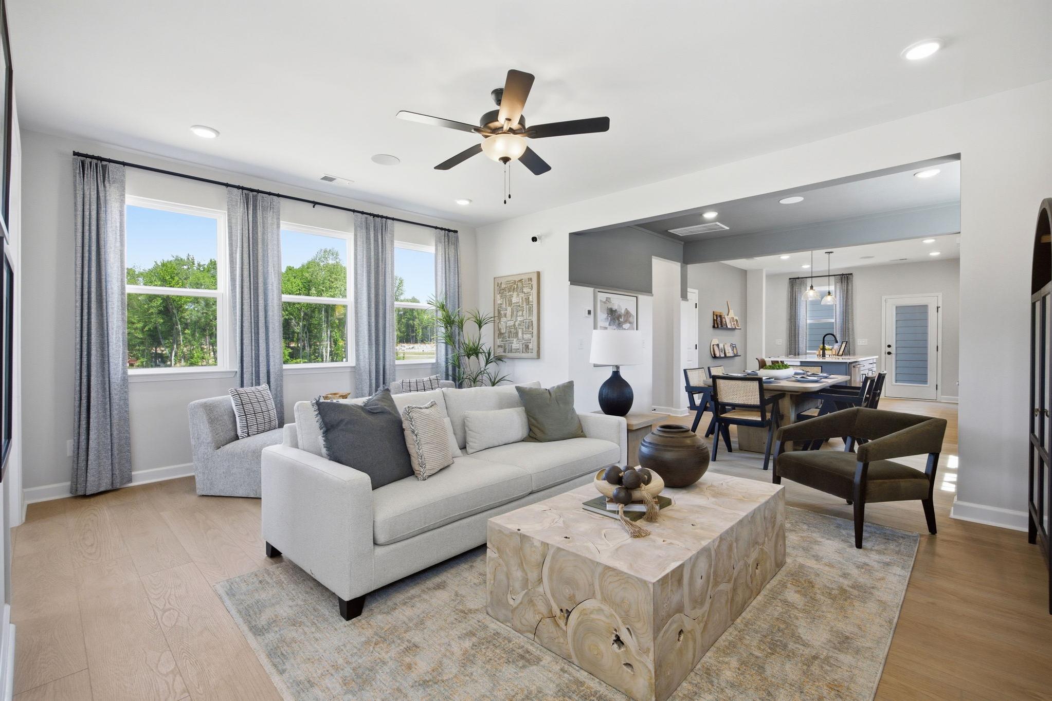 Open-concept living room at Forestville Yard in Knightdale, NC with natural wood coffee table and Davidson Homes design.