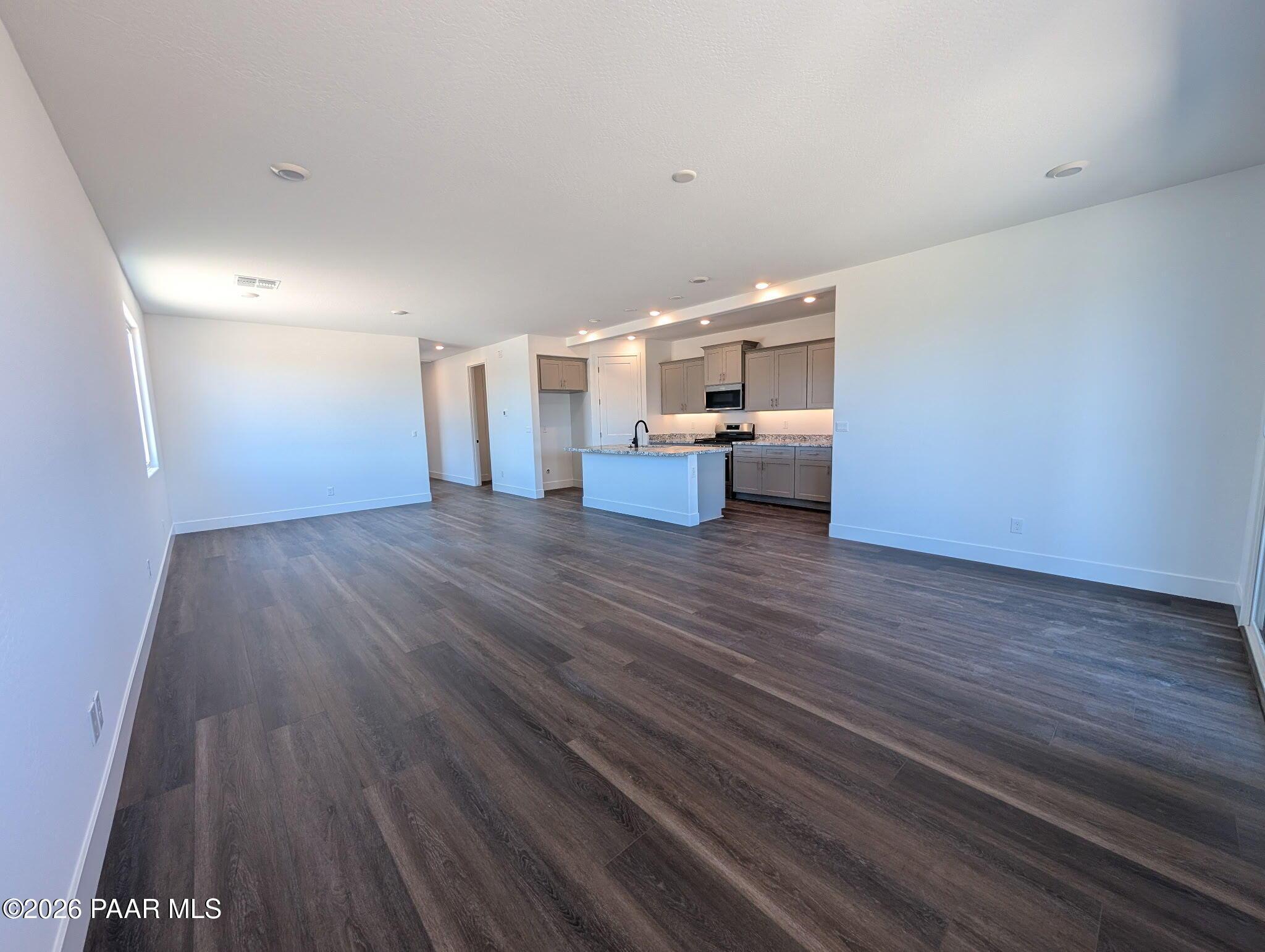 Open-concept living room and kitchen in The Frontier II F floor plan at South Ranch Western Collection, Prescott, Arizona.