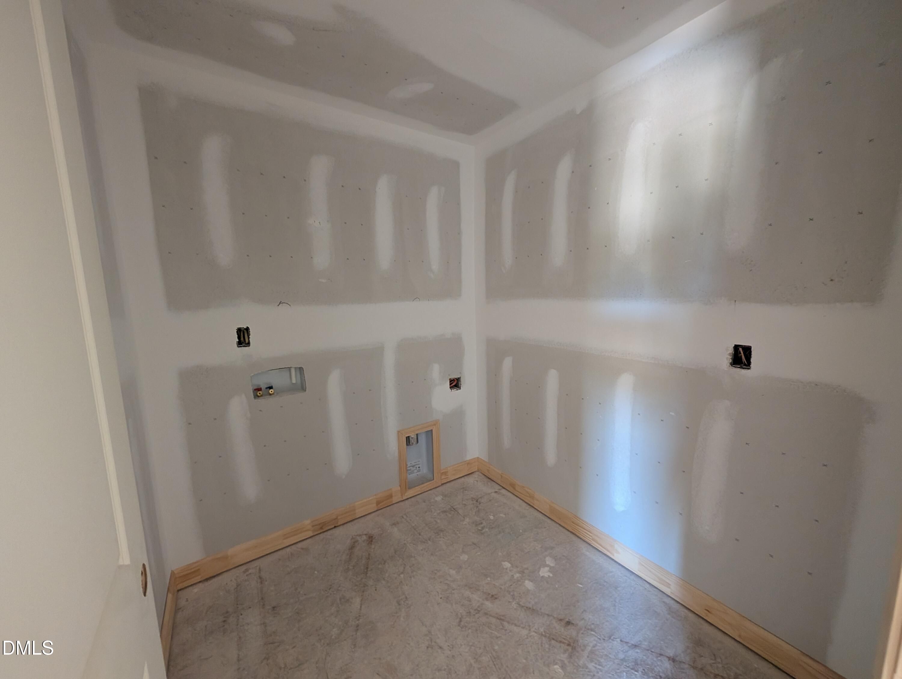 Unfinished laundry room with wall hookups in The Chestnut floor plan at Wendell Ridge, Wendell, North Carolina.
