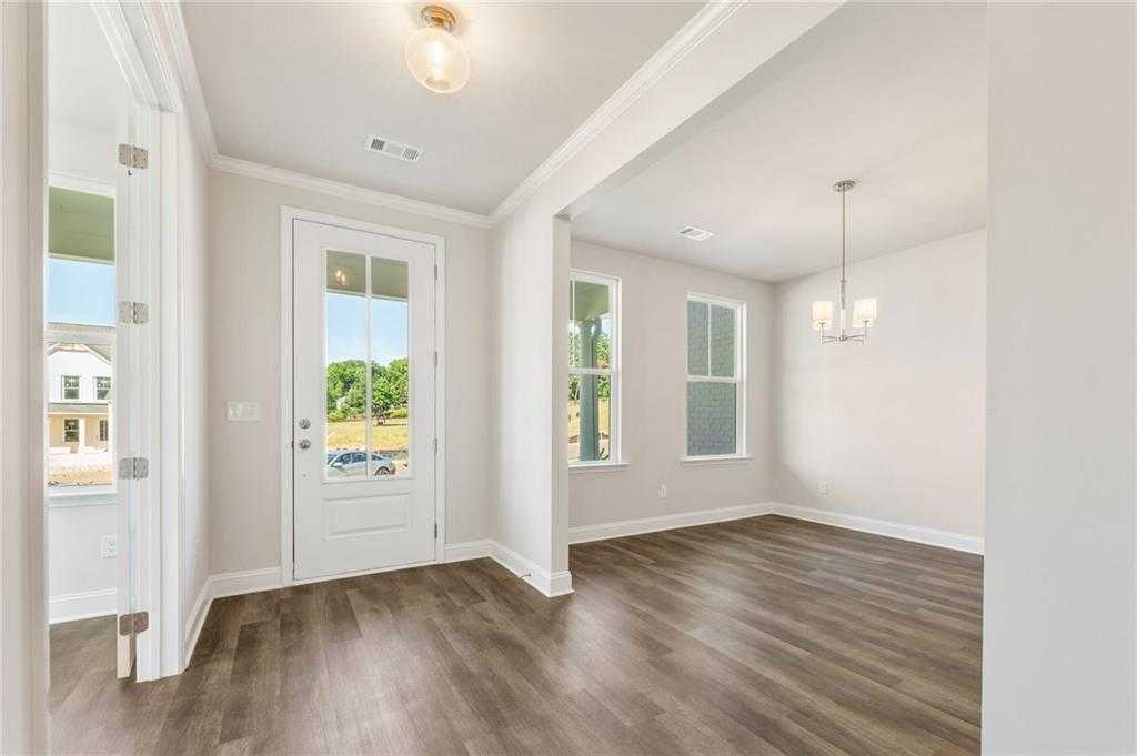 Bright foyer with wood flooring, arched doorway, and natural light in Davidson Homes The Danbury E, Buford, Georgia