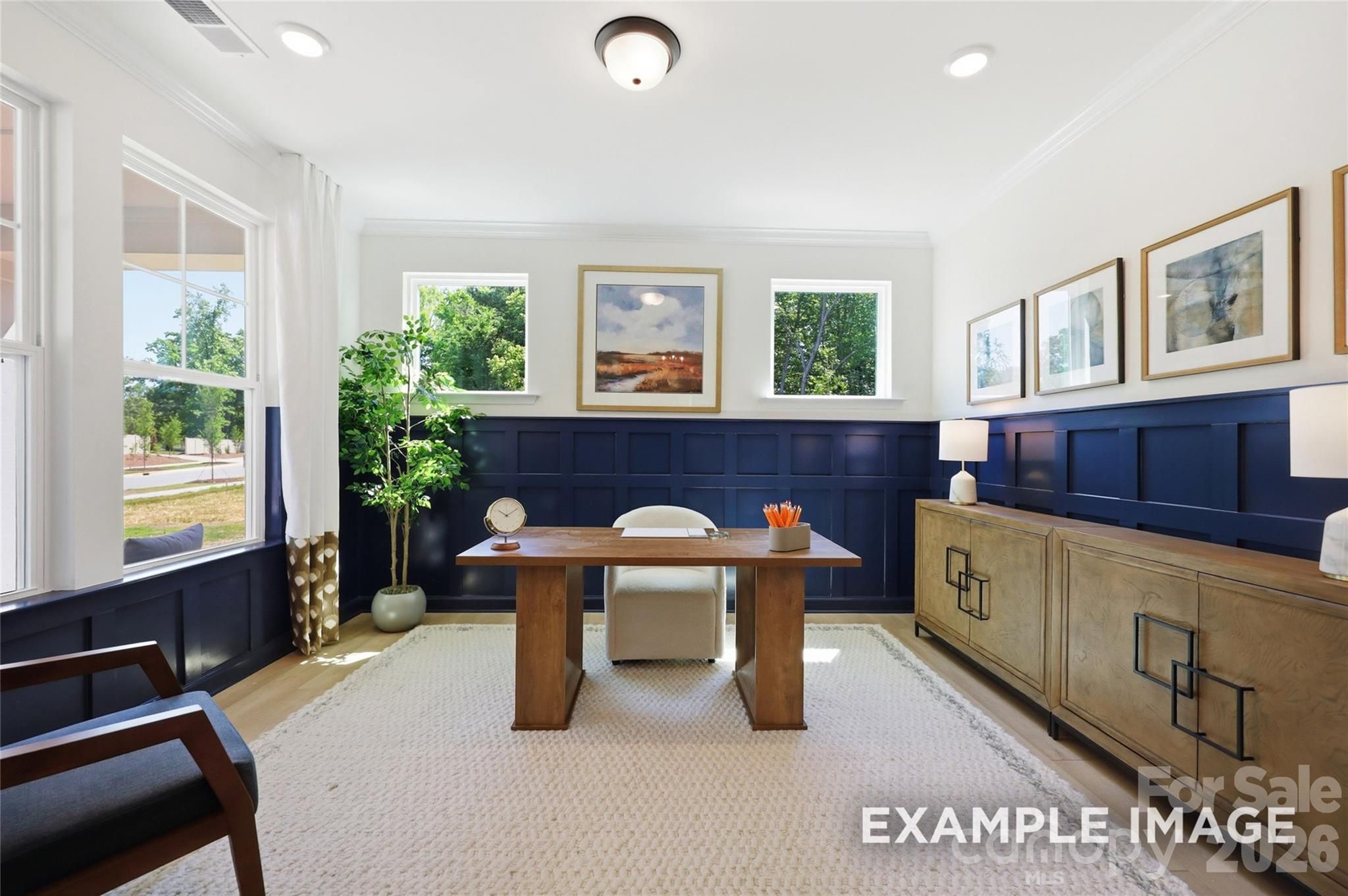 Elegant home office with navy wainscoting, wood desk, and natural light in Davidson Homes The Aspen B, Mooresville, NC