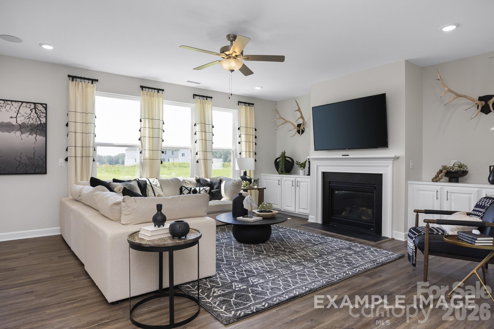 Modern open-concept living room with fireplace in The Hickory C II floor plan by Davidson Homes in Windgate, Mooresville.