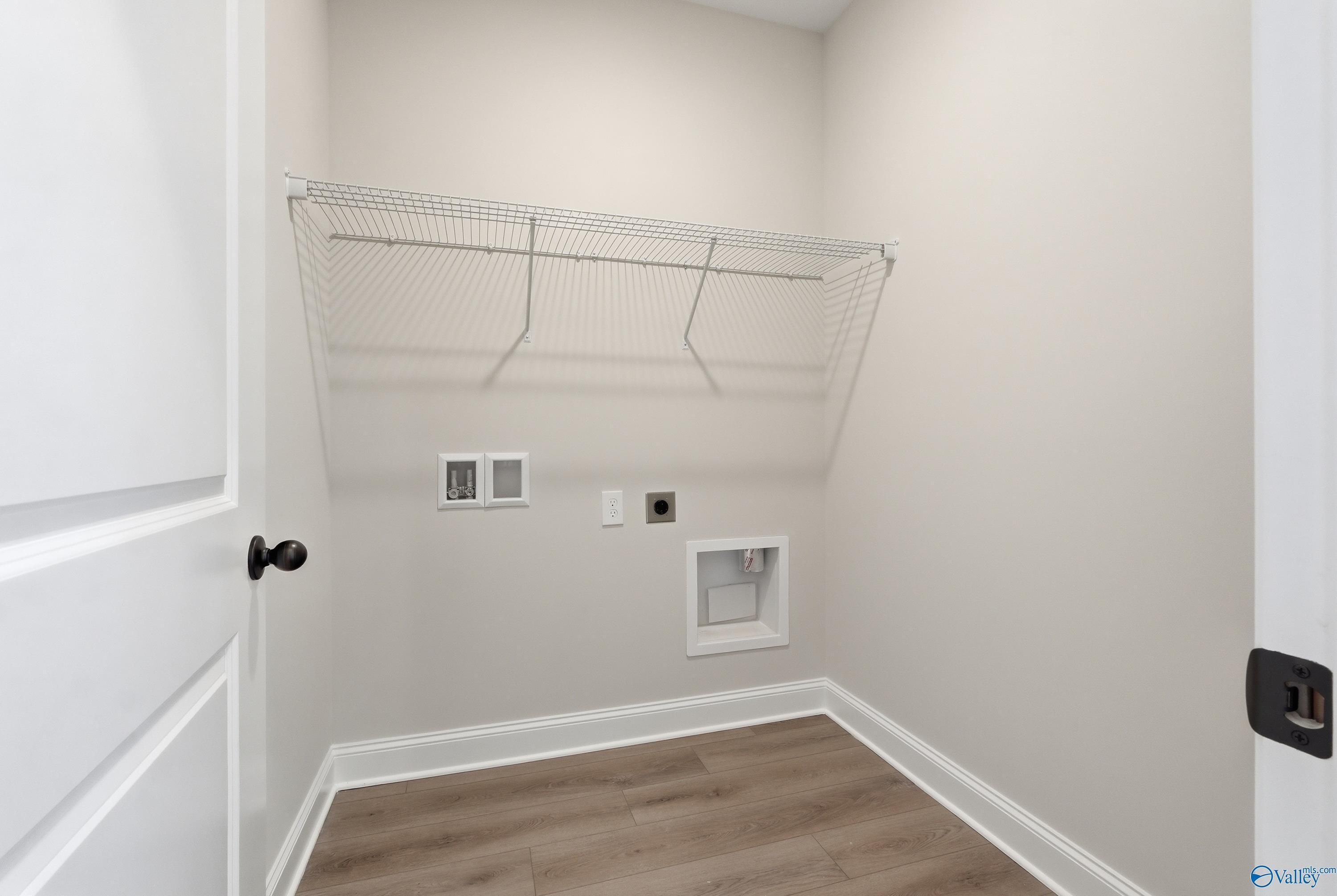Spacious laundry room with wire shelving, washer/dryer hookups in Davidson Homes The Franklin C, Lynn Meadows, Meridianville, Alabama