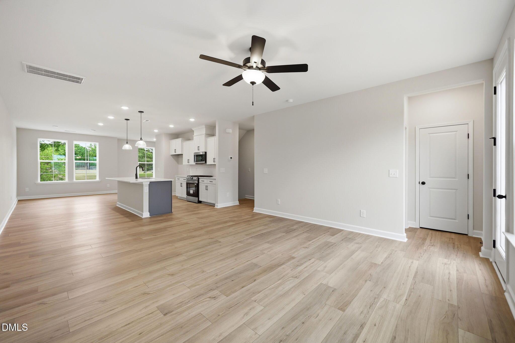 Open-concept living room and kitchen in The Mitchell floor plan by Davidson Homes at Camden Park in Knightdale, NC.