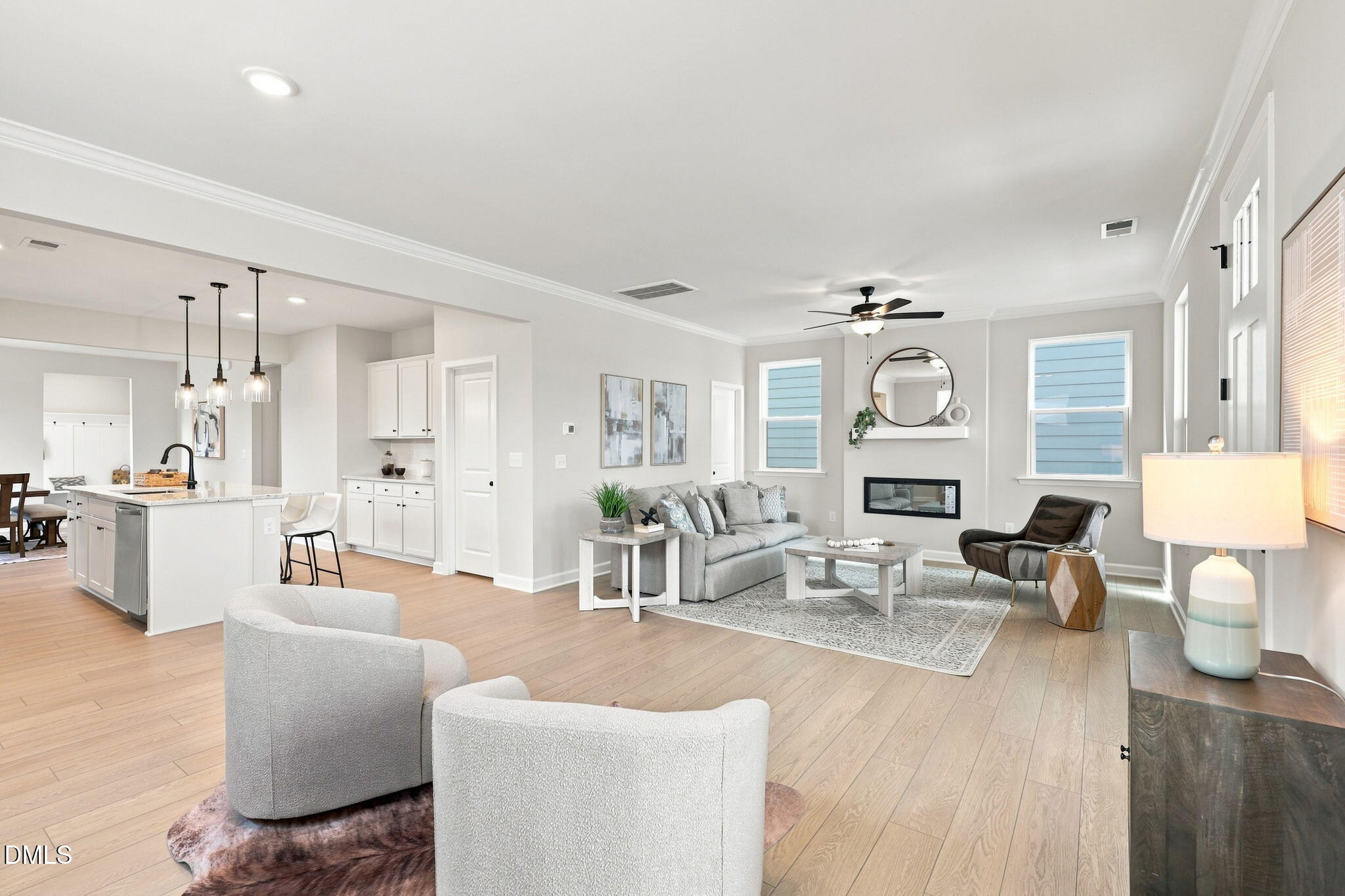 Open-concept living room with fireplace and kitchen in The Harris C floor plan at Forestville Yard, Knightdale, NC.