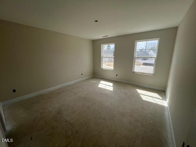 Bright secondary bedroom with beige walls, large windows, and natural light in Davidson Homes Preston A, Lillington, NC