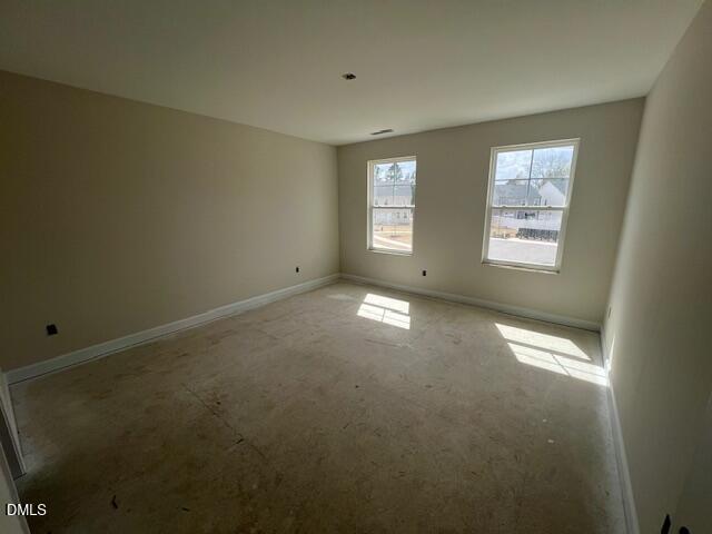 Bright secondary bedroom with beige walls, large windows, and natural light in Davidson Homes Preston A, Lillington, NC