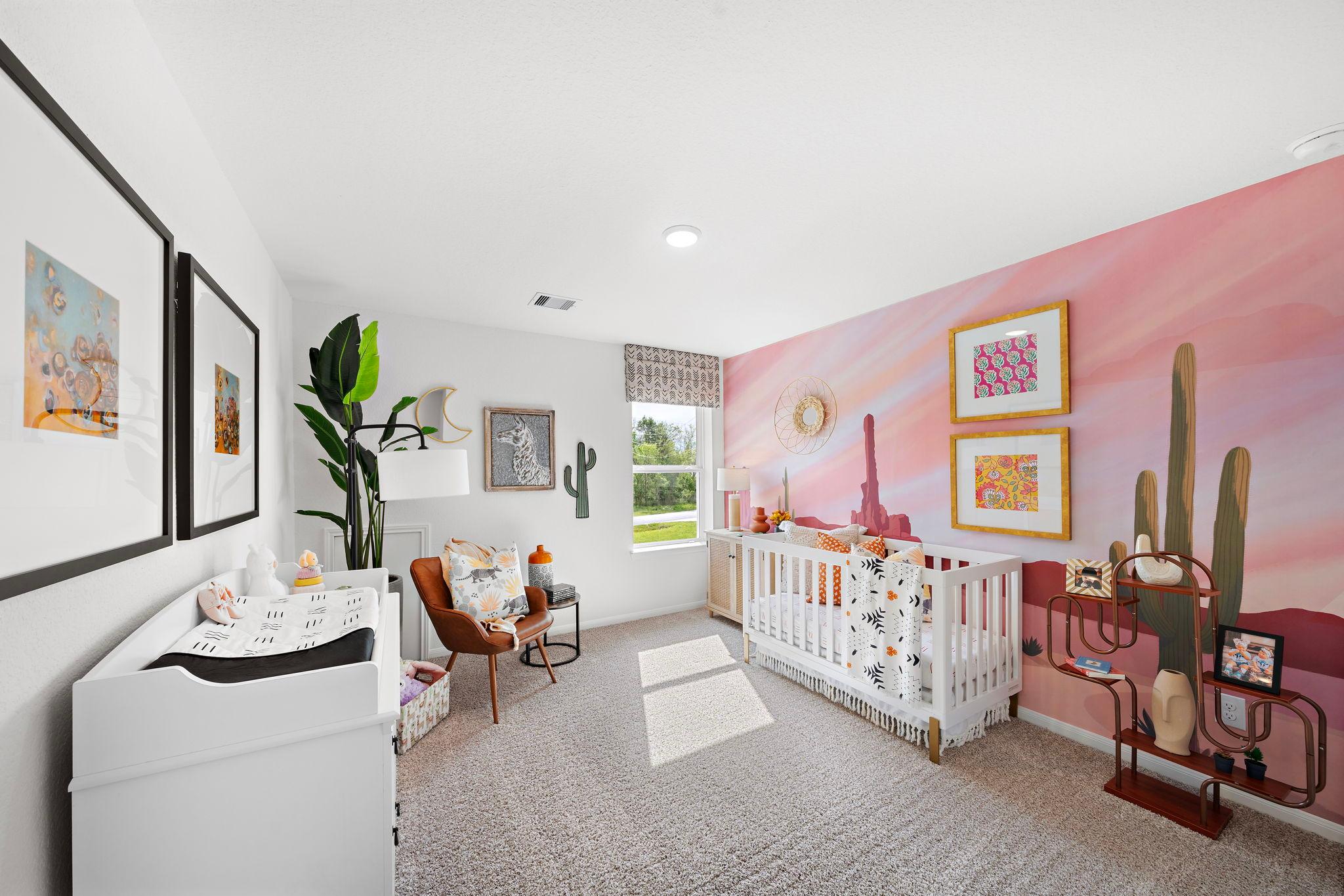 Desert-themed nursery at The Villages at WestPointe in Dayton Texas with pink cactus mural, white crib, and changing table
