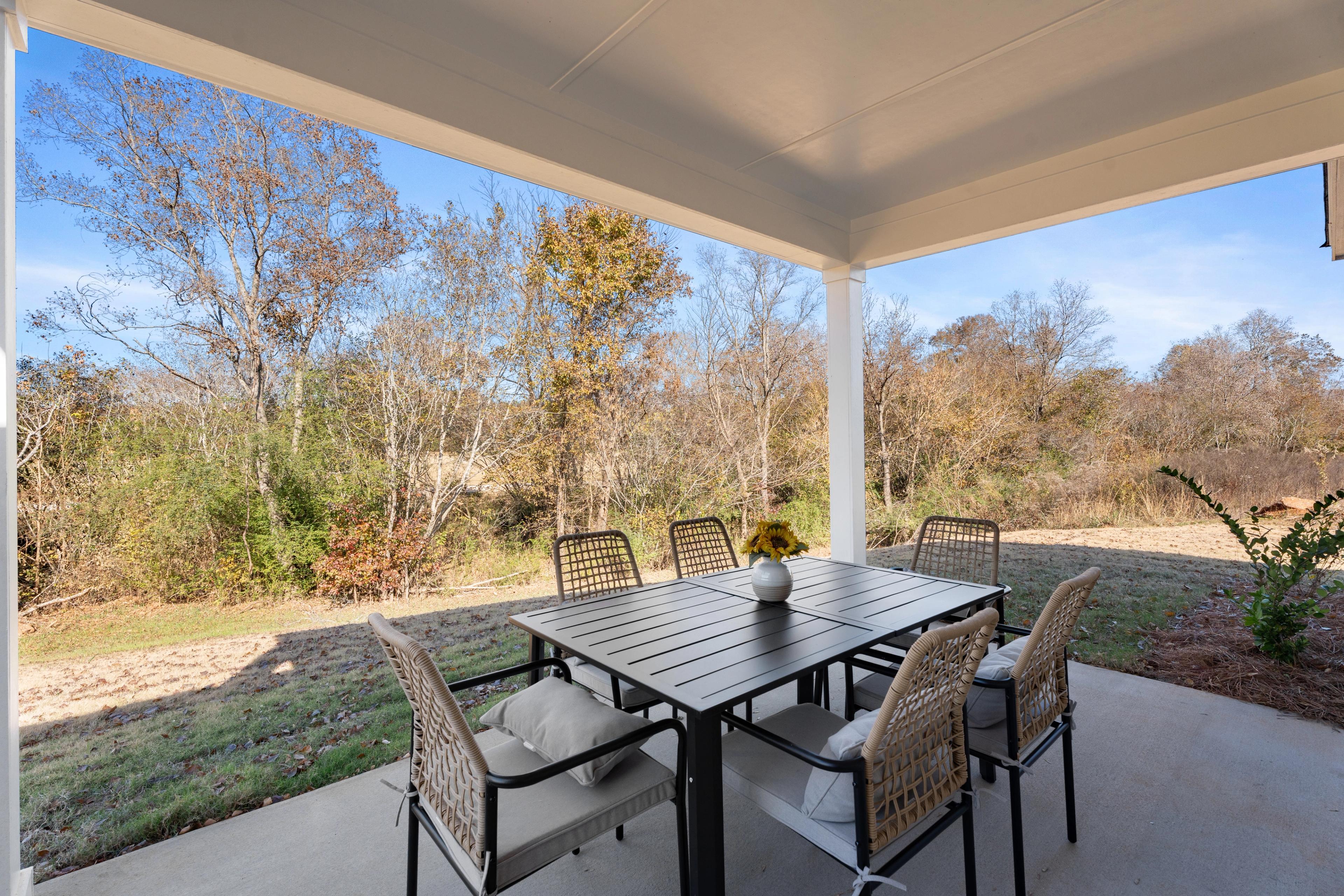 Covered back patio with table and chairs