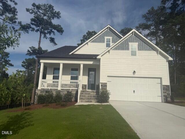 Front exterior of Davidson Homes' The Birch II A featuring covered porch, 2-car garage, and landscaped yard in Aberdeen, NC