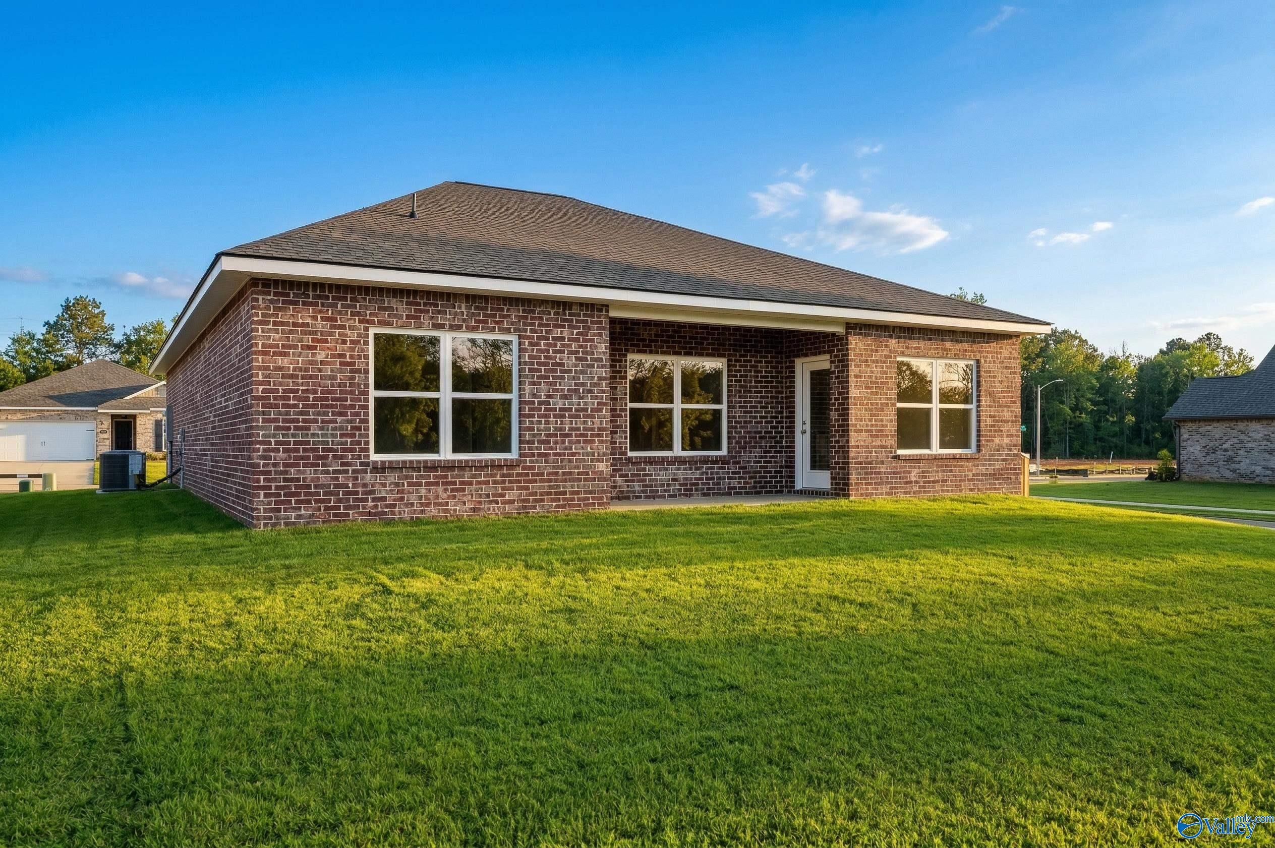 Brick exterior of the Asheville C floor plan by Davidson Homes featuring a spacious backyard in Spragins Cove, Huntsville.
