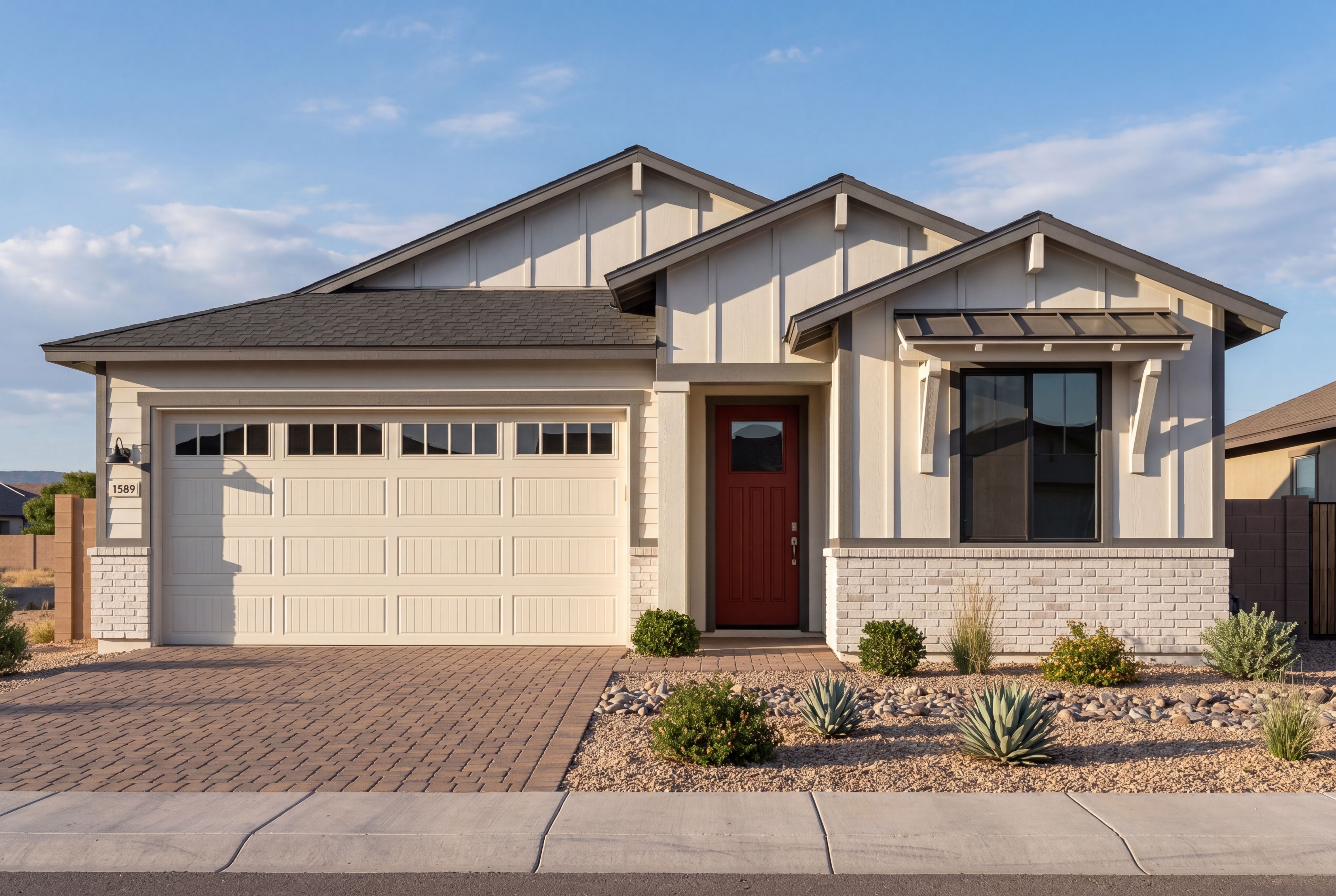 Modern single-story exterior of The Frontier II G in Prescott with 3-car garage, white brick, and red front door.