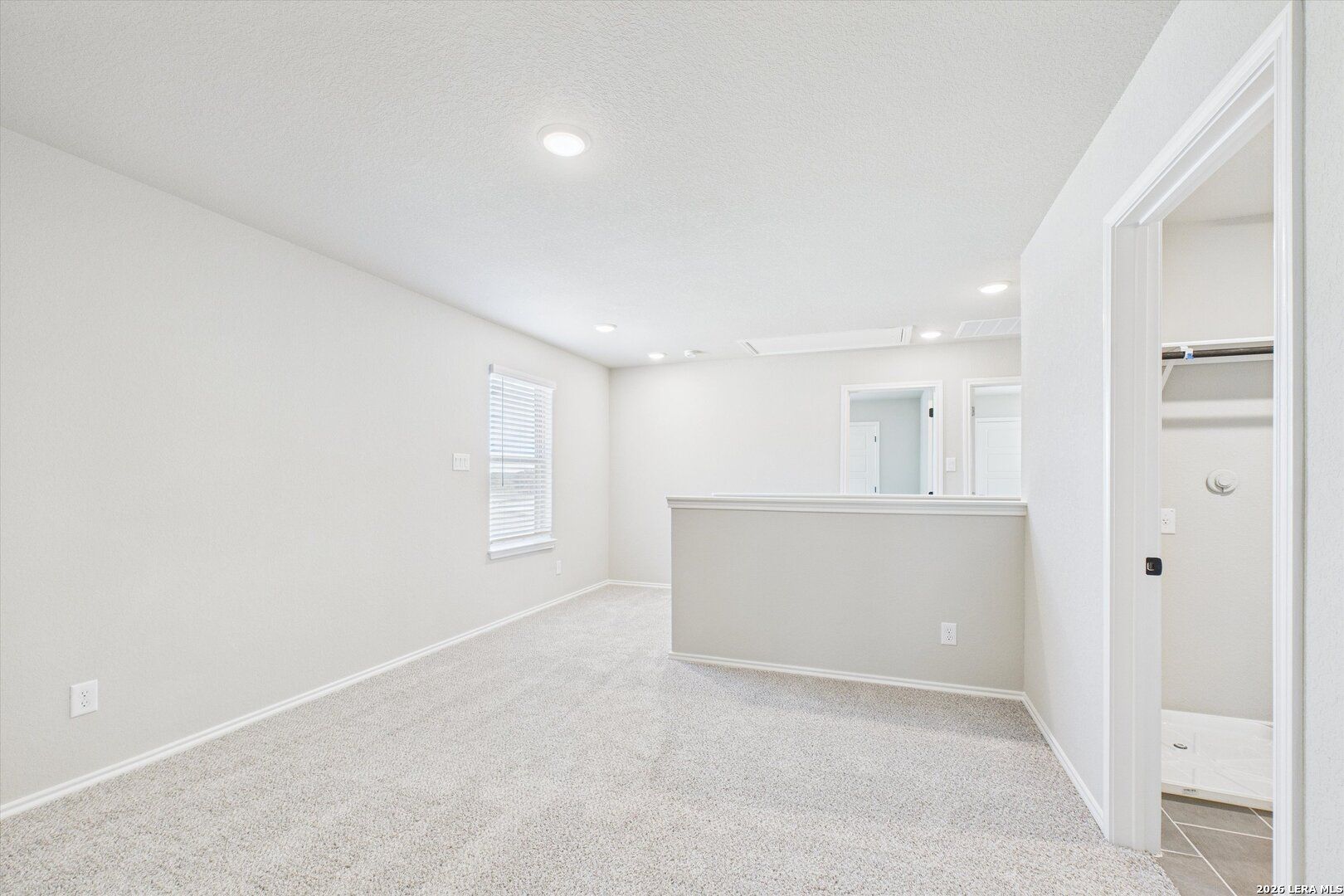 Spacious master bathroom with walk-in shower, dual vanity, and tiled flooring in Davidson Homes Charlotte A, San Antonio
