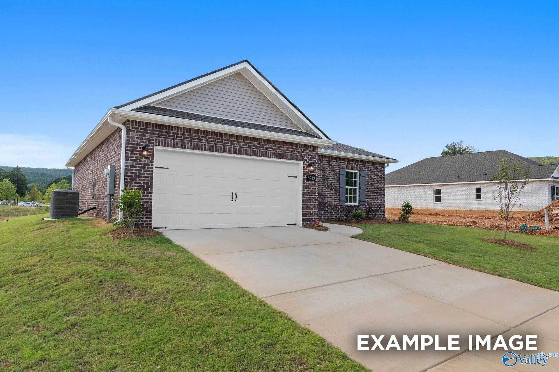 Modern 1-story brick home with 2-car garage, driveway, and lush lawn in Ramsay Cove, Owens Cross Roads, Alabama - Davidson Homes The Butler