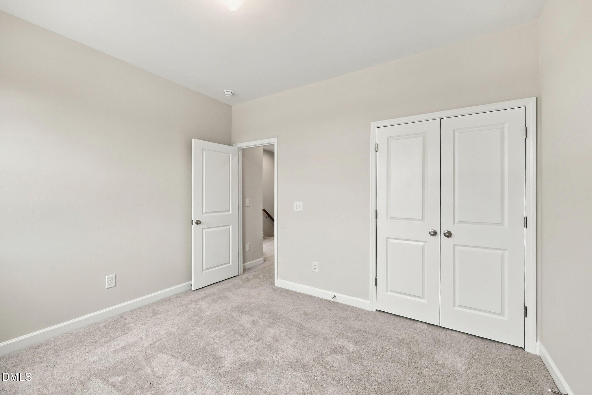 Spacious carpeted bedroom with dual-door closet in Davidson Homes' The Alexander B, 3-bedroom home in Knightdale, NC