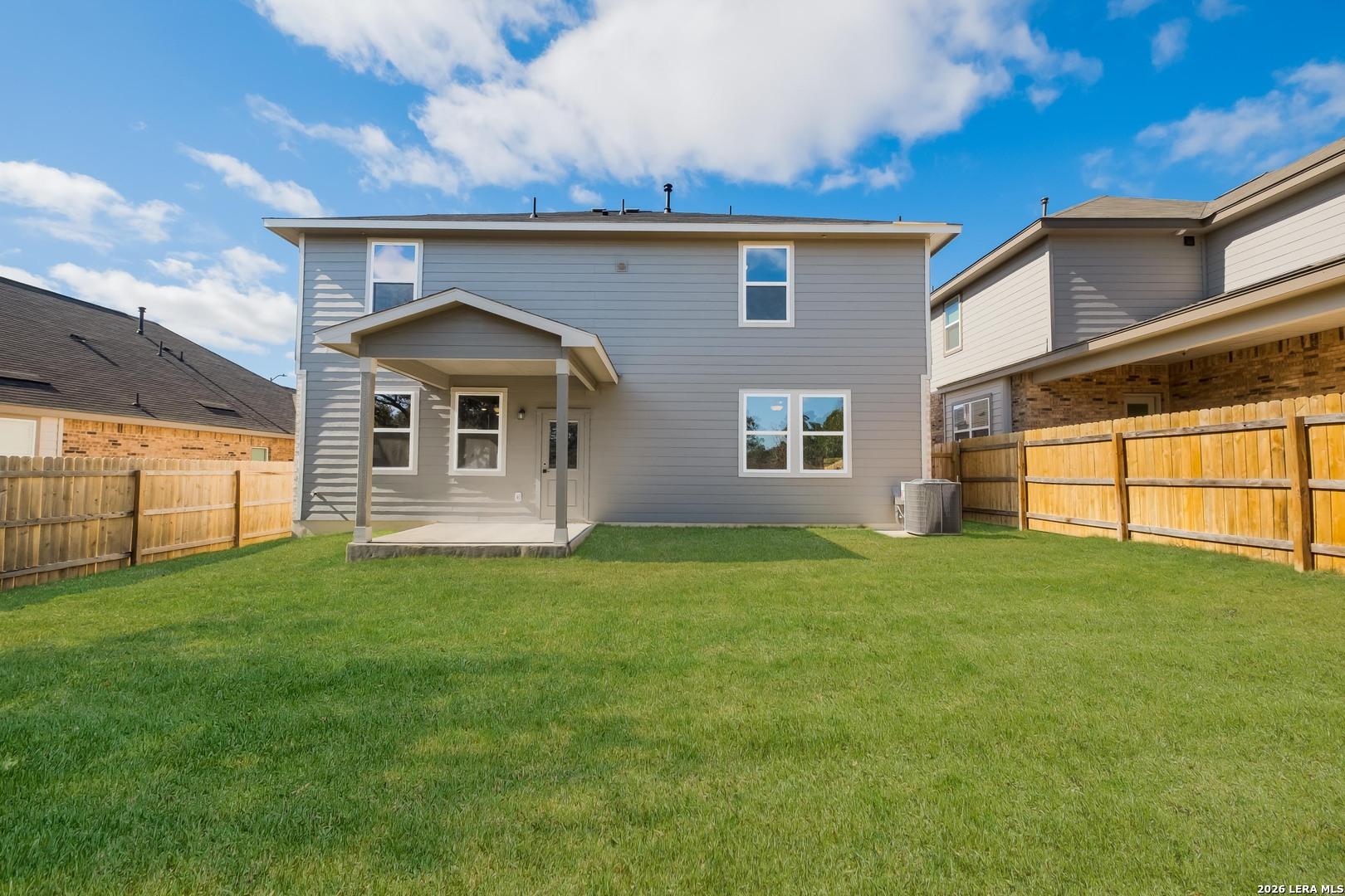 Covered back patio with spacious grassy backyard in two-story 4-bedroom Davidson Homes The Douglas E, Bricewood, San Antonio, Texas