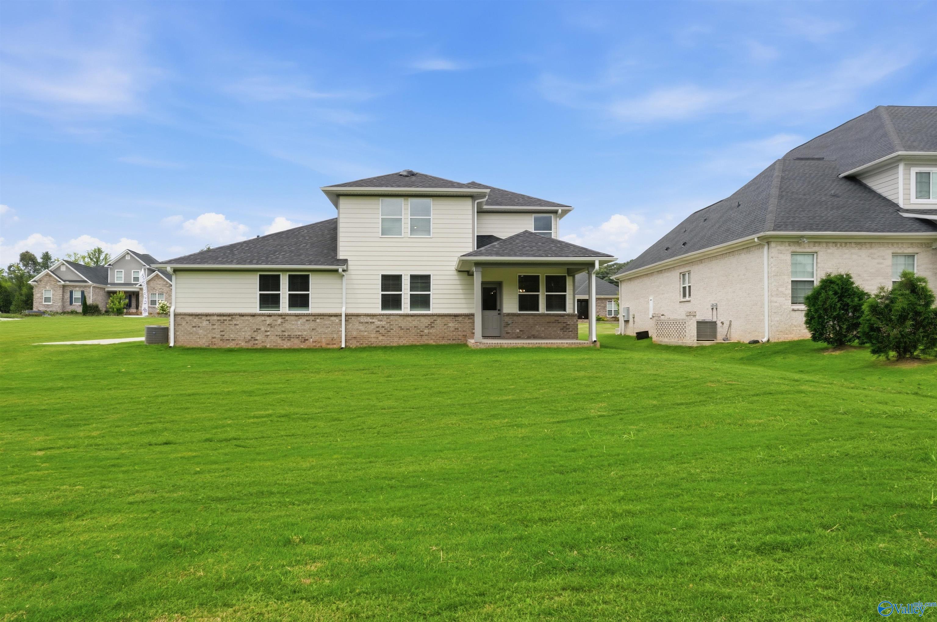Rear exterior view of The Dorado floor plan by Davidson Homes featuring a spacious backyard in Riverton Preserve, Huntsville.