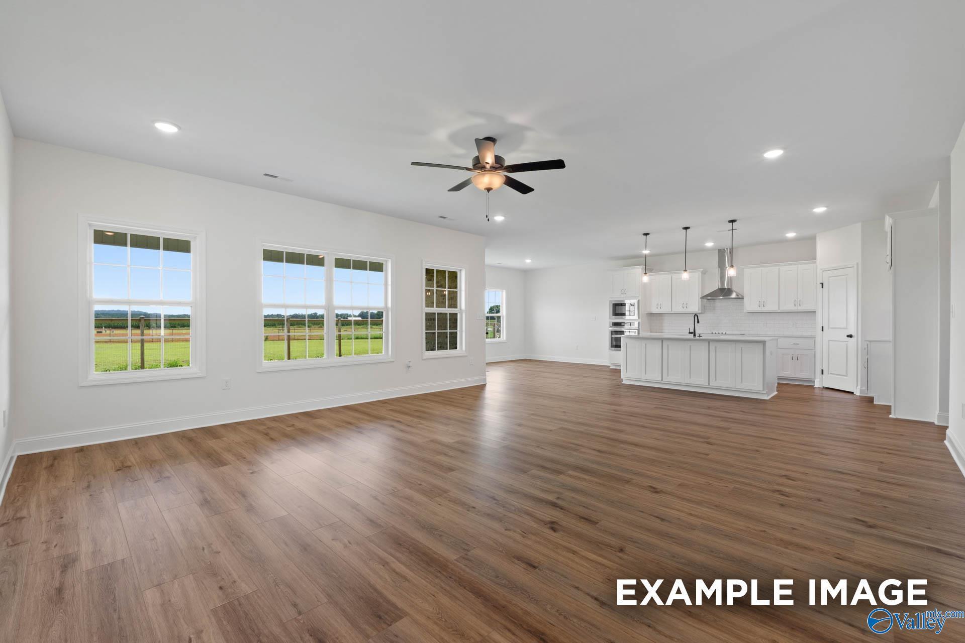 Open-concept living room and kitchen in The Rockford B floor plan by Davidson Homes in Briercreek, Meridianville, AL.