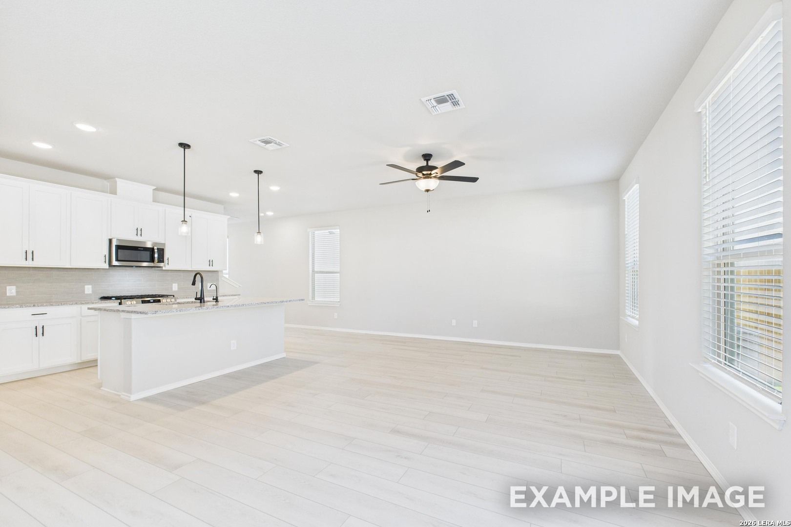 Open-concept kitchen and living area in The Charlotte B floor plan by Davidson Homes in Cedar Heights, San Antonio, Texas.