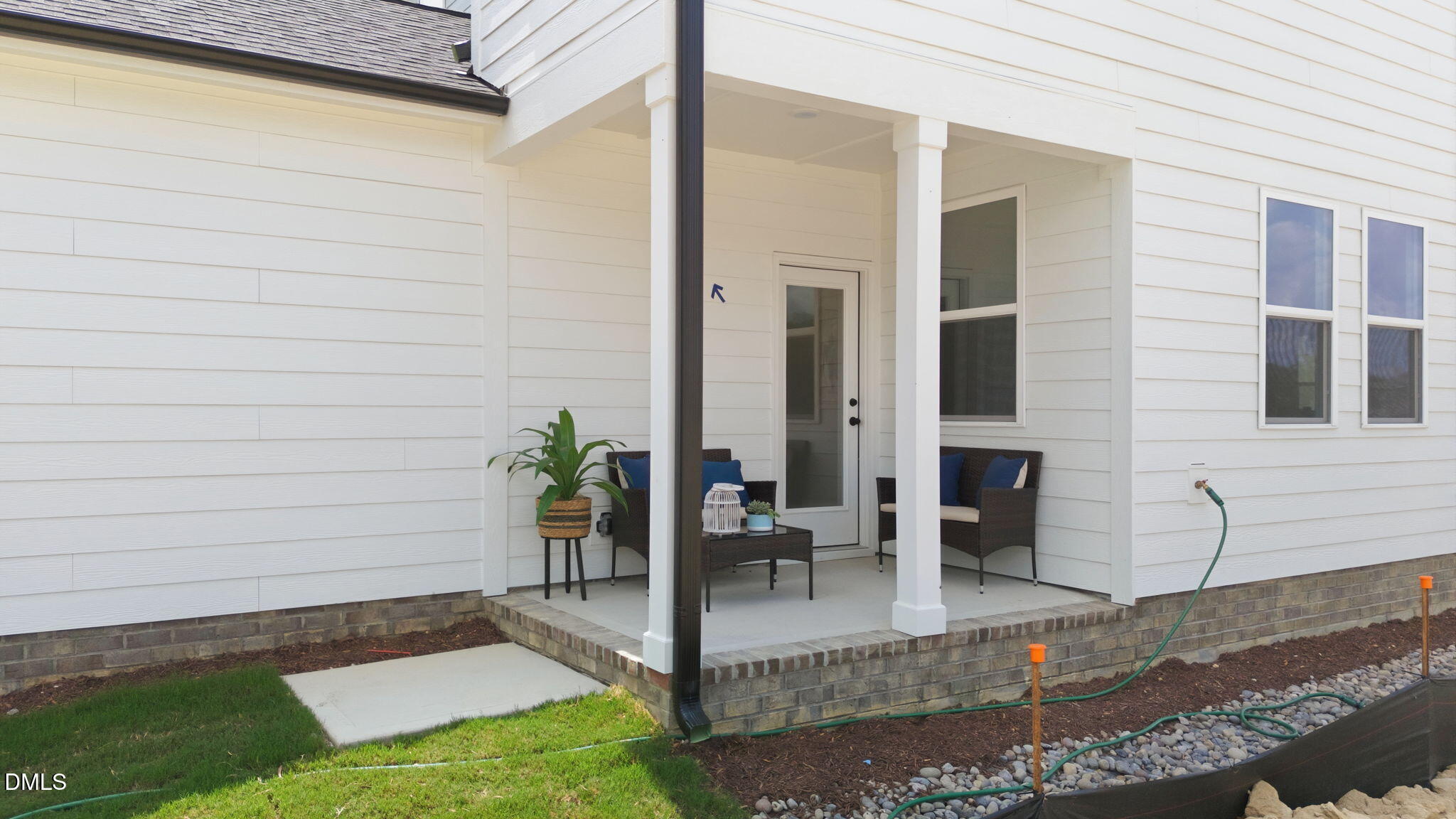 Covered back patio with outdoor seating at The Harris C floor plan in Forestville Yard, Knightdale, North Carolina.