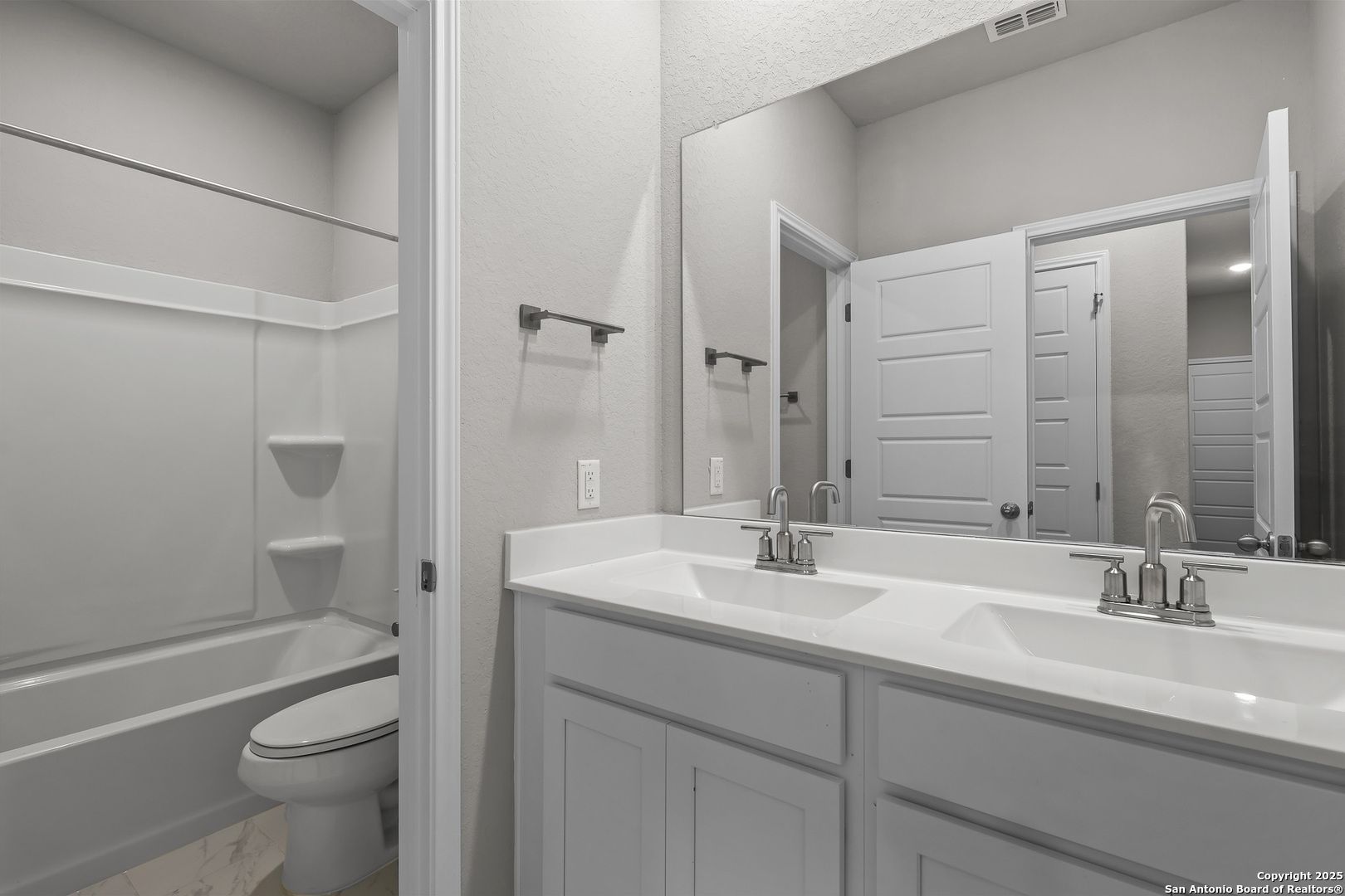 Spacious master bathroom with double vanity, separate tub, shower, and toilet in Davidson Homes The Colorado B, San Antonio