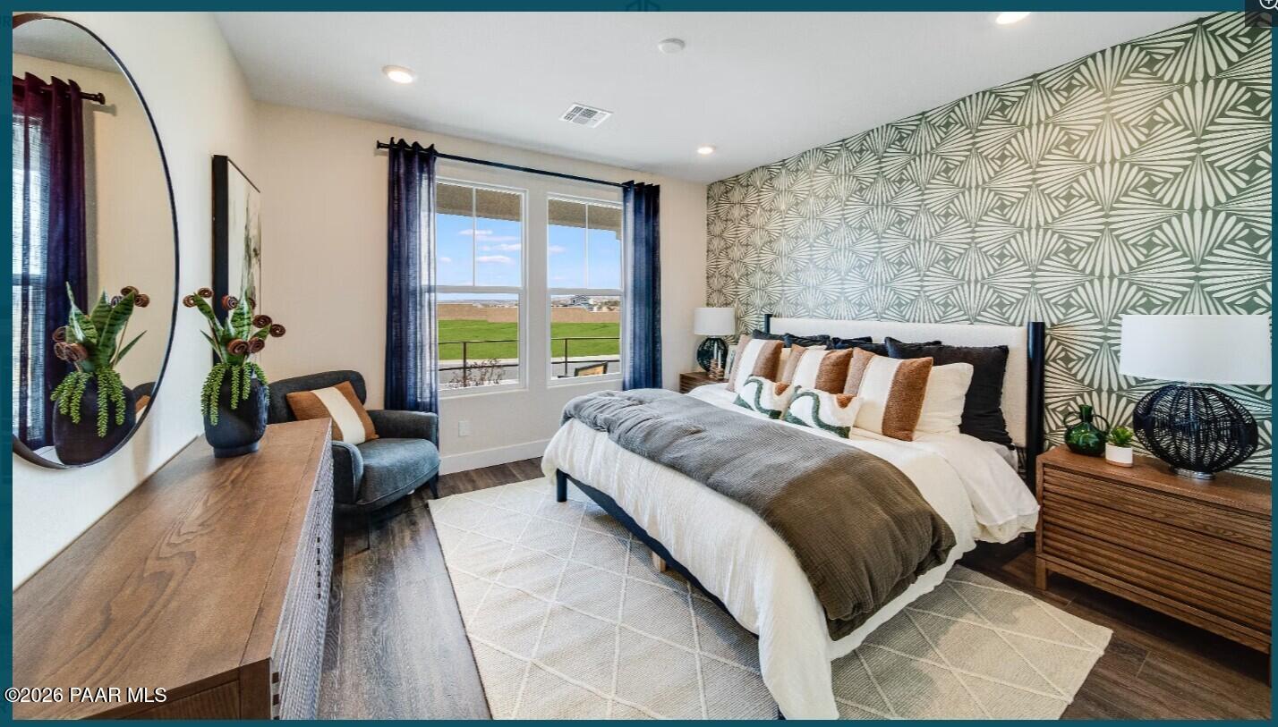 Modern bedroom with geometric accent wall in The Boulder II H floor plan at South Ranch, Prescott, Arizona.