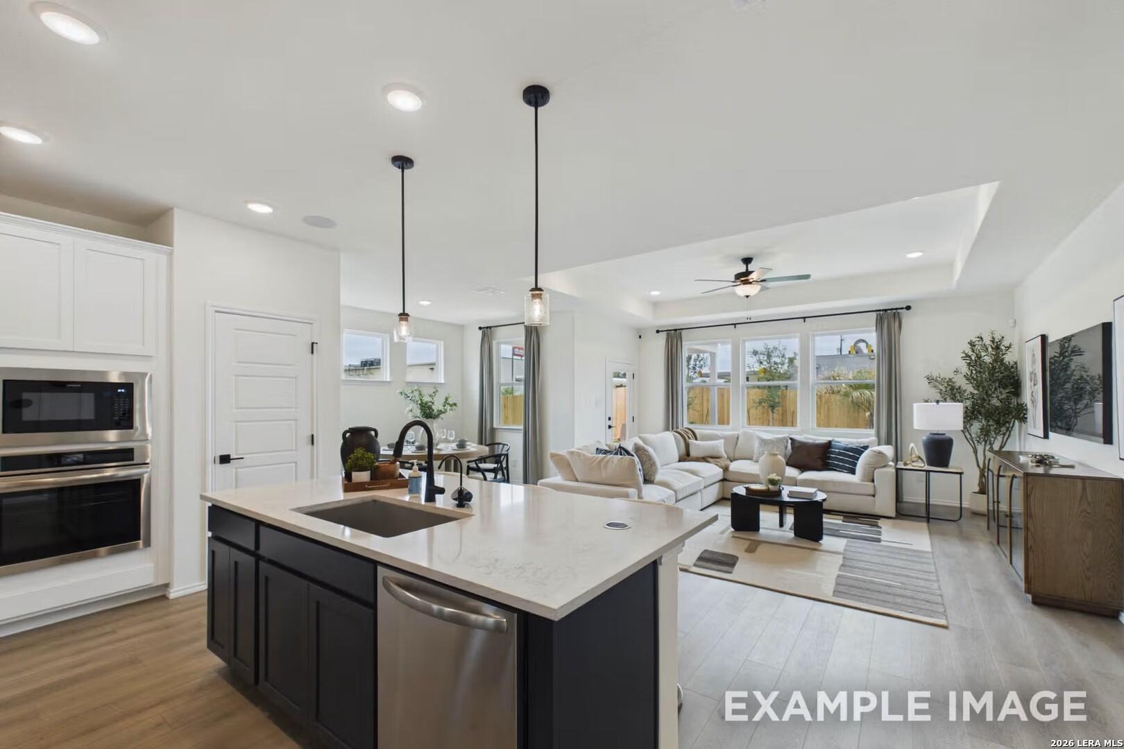 Open-concept kitchen and living area in The Laurel I floor plan by Davidson Homes in Rayburn Valley, San Antonio.