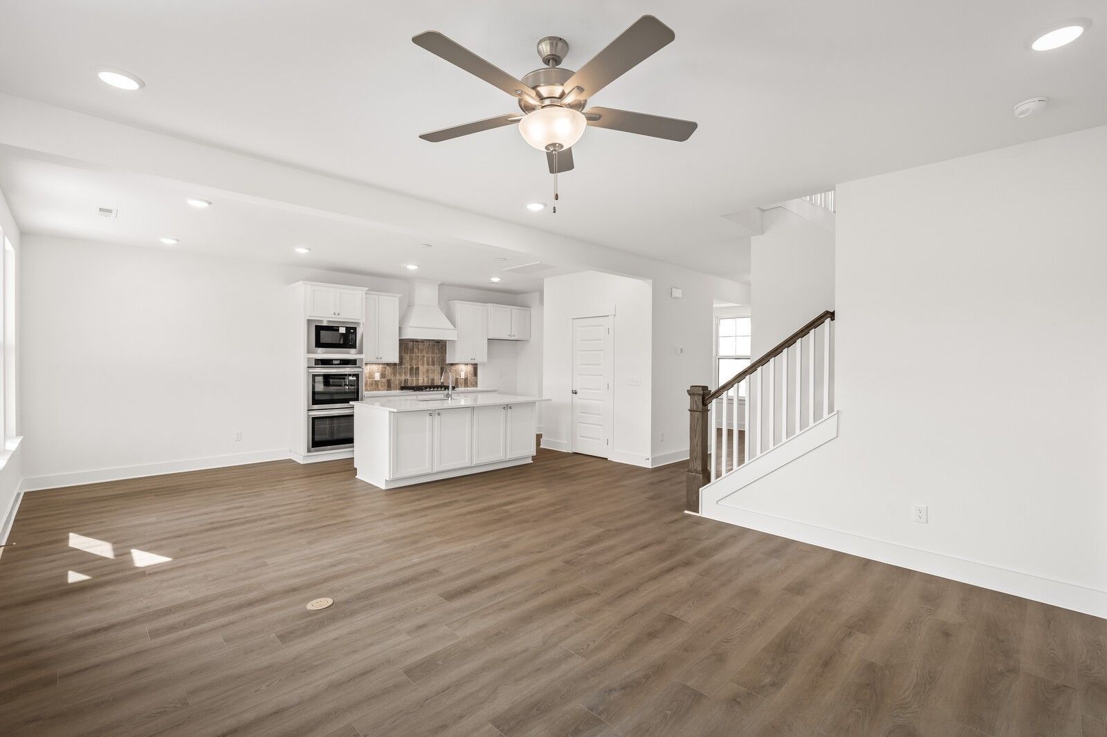 Open-concept kitchen and living area in The Willow D floor plan by Davidson Homes in Benders Cove, Mt. Juliet, Tennessee.