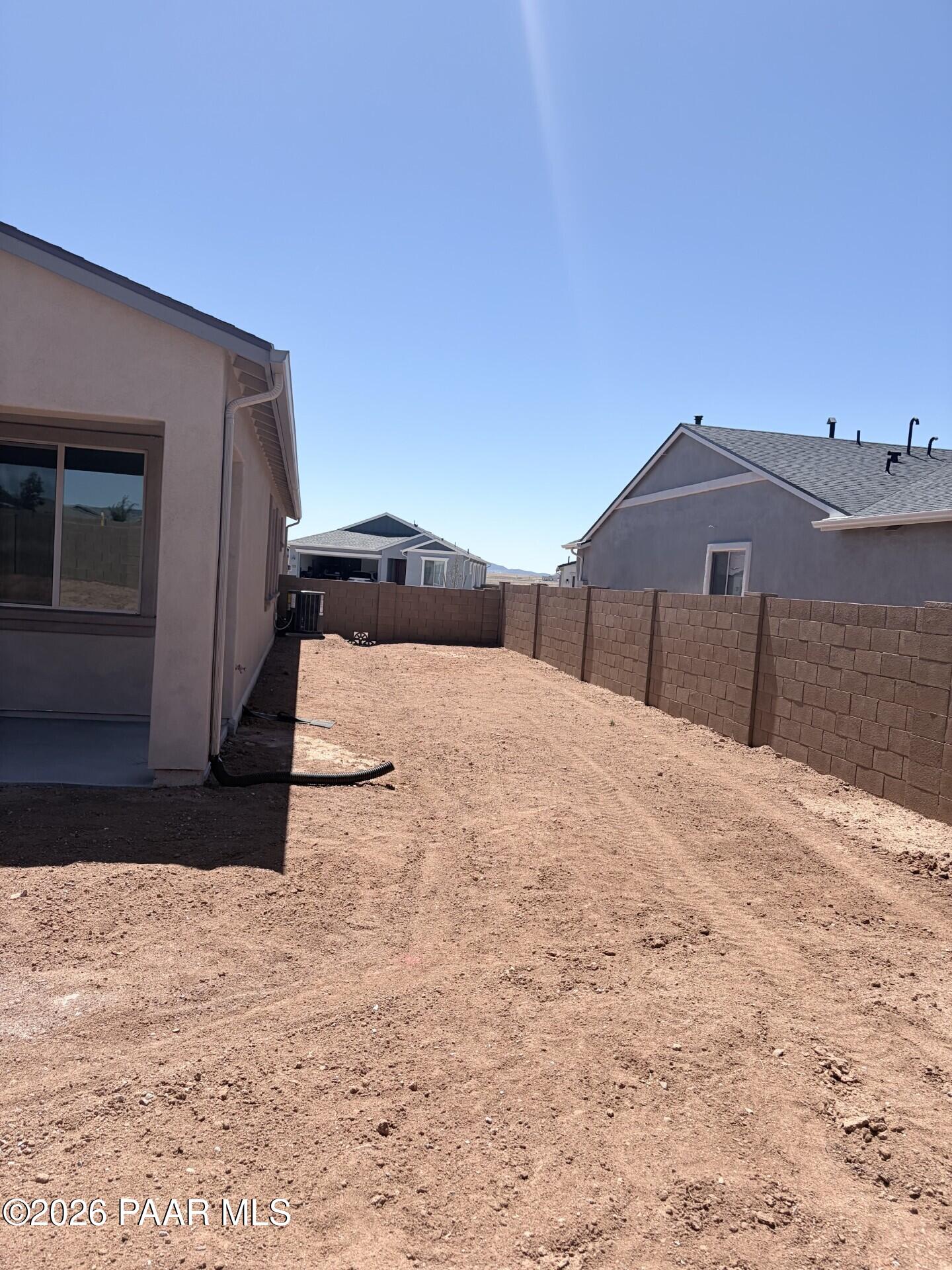Unfinished backyard with block wall fencing at The Frontier A floor plan in North Ridge, Pronghorn Ranch, Prescott Valley.