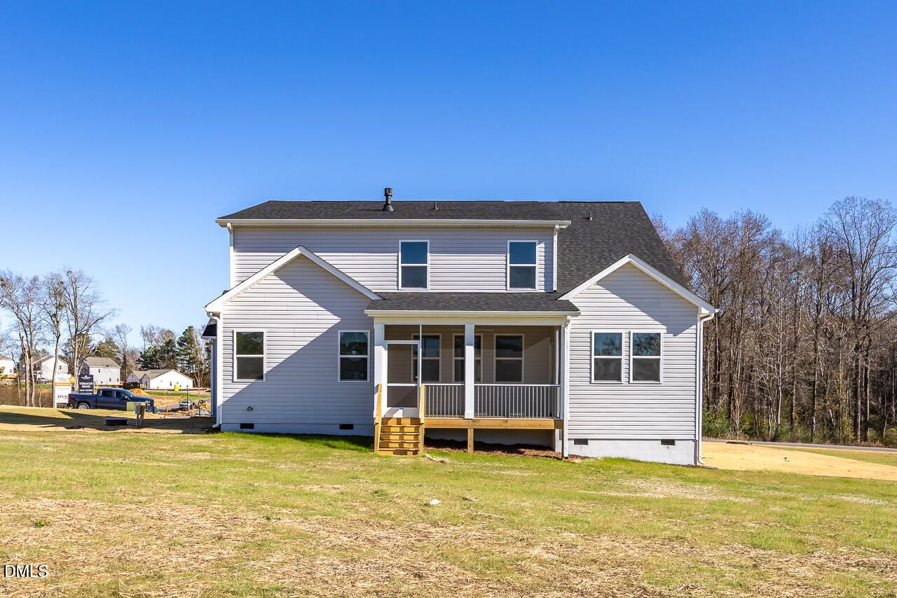 Back view of two-story 4-bedroom Davidson Homes The Cypress B II with covered screened porch and 3-car garage in Tobacco Road, Angier, NC
