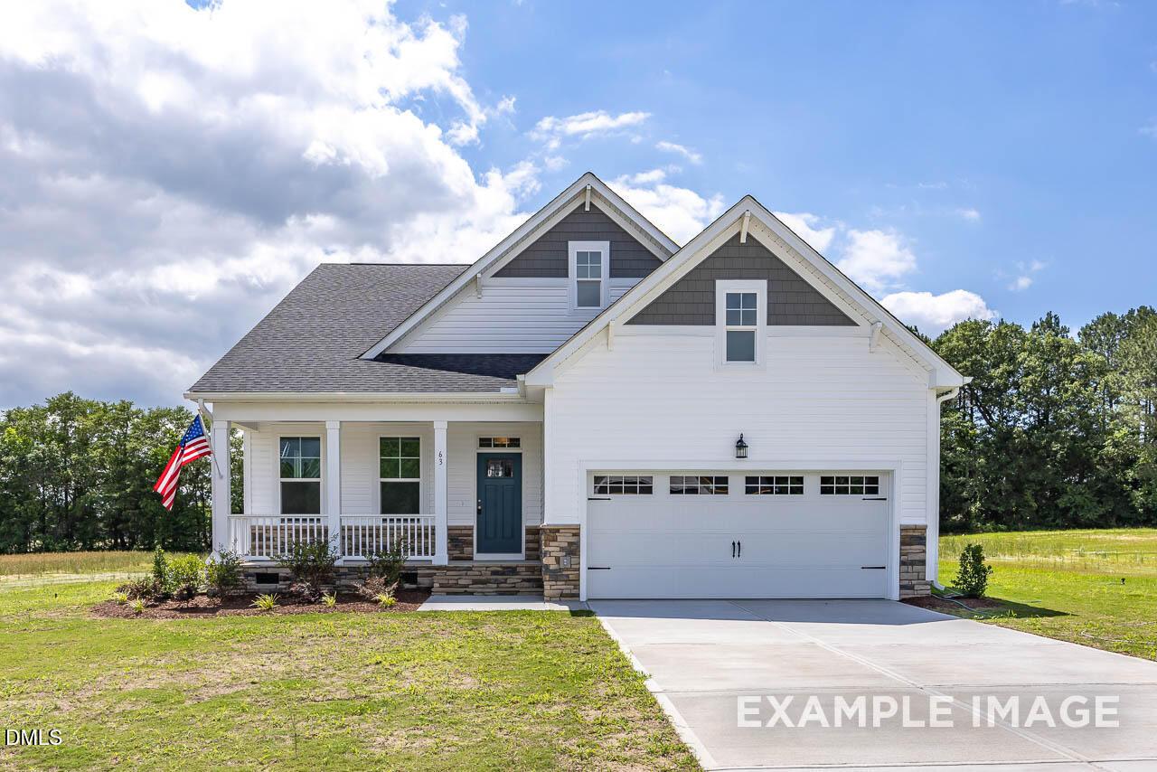 Two-story Birch II A model home by Davidson Homes with a covered front porch in Tobacco Road, Angier, North Carolina.