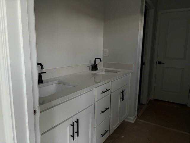 Modern double vanity with white shaker cabinets and matte black faucets in The Rabun C master bath, Davidson Homes, Winder GA