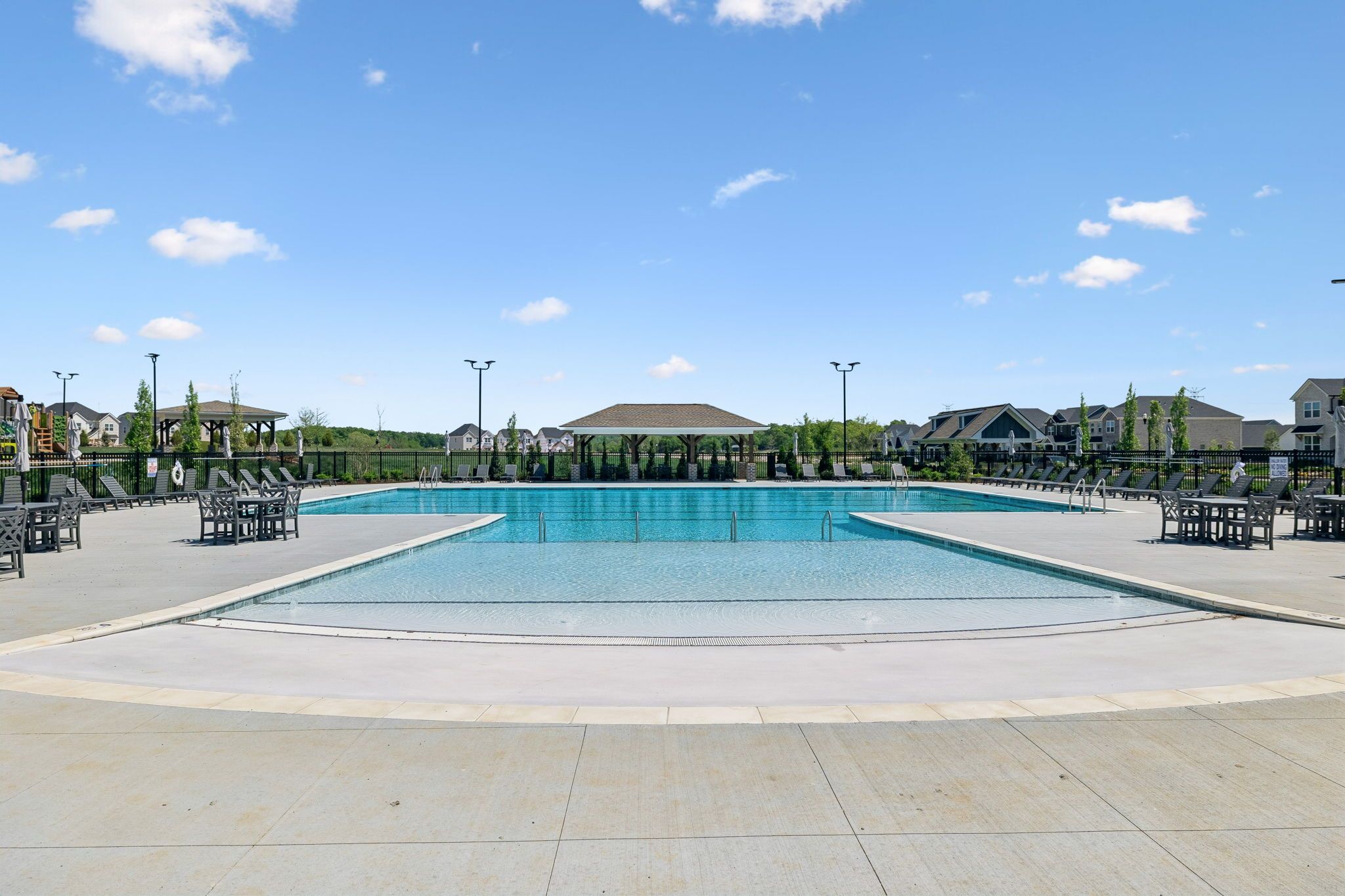 Resort-style swimming pool at Bradshaw Farms in Mt. Juliet, TN, by Davidson Homes with lounge seating and cabana.