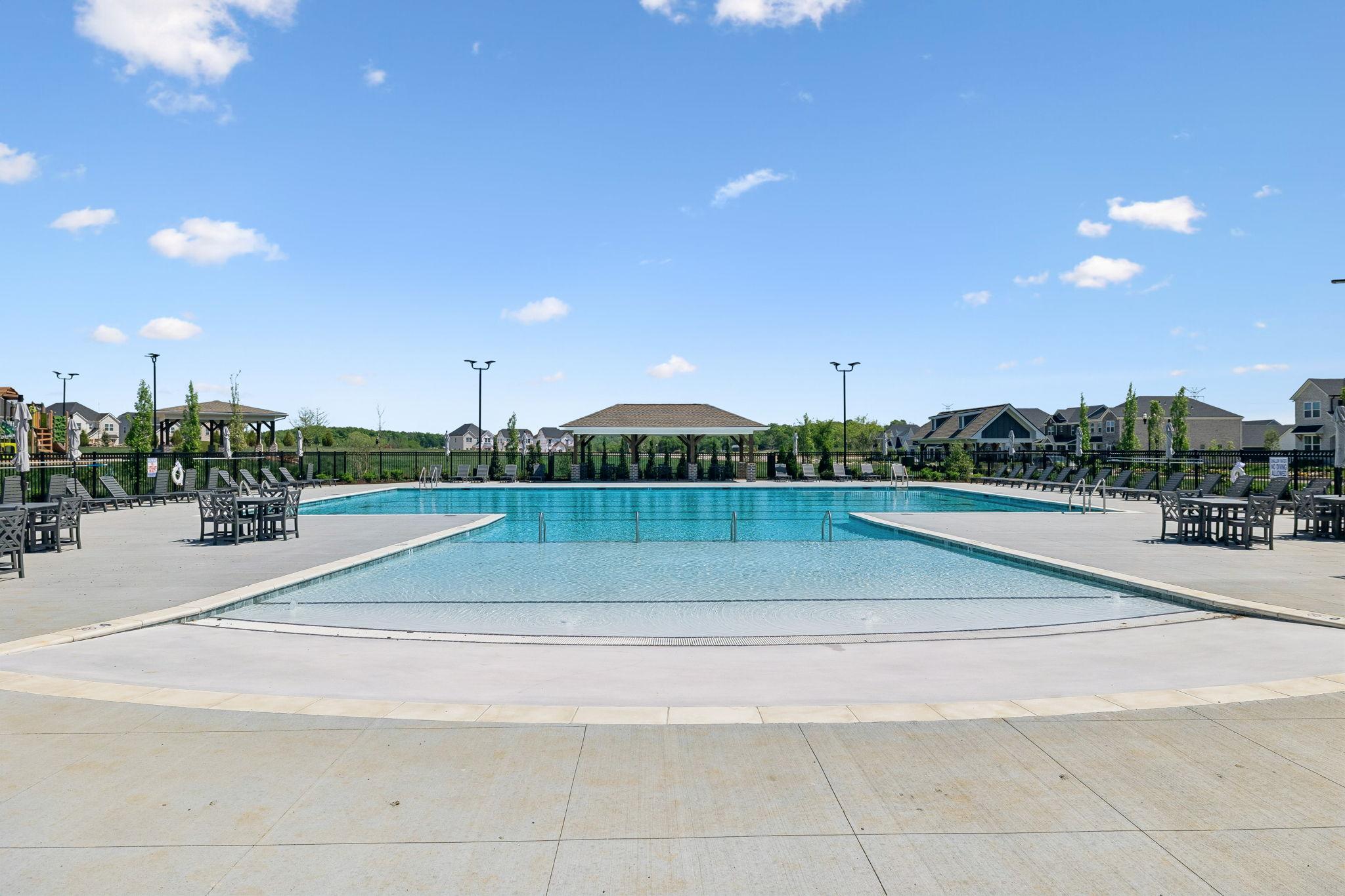Resort-style swimming pool at Bradshaw Farms in Mt. Juliet, TN, by Davidson Homes with lounge seating and cabana.
