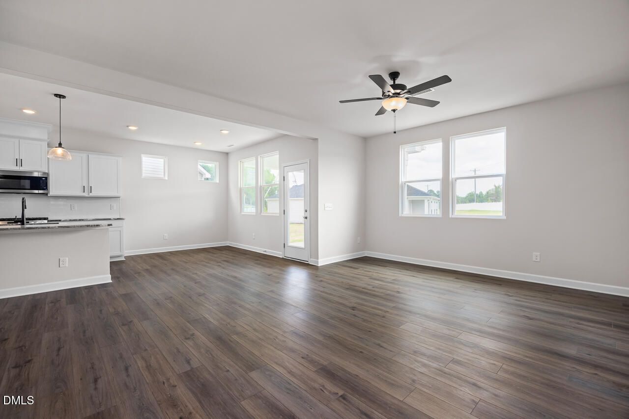 Open-concept living room and kitchen in The Willow B floor plan by Davidson Homes in Woodland Crossing, Zebulon, NC.