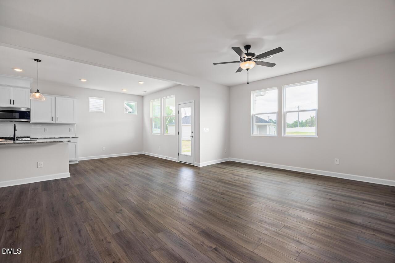 Open-concept living room and kitchen in The Willow B floor plan by Davidson Homes in Woodland Crossing, Zebulon, NC.