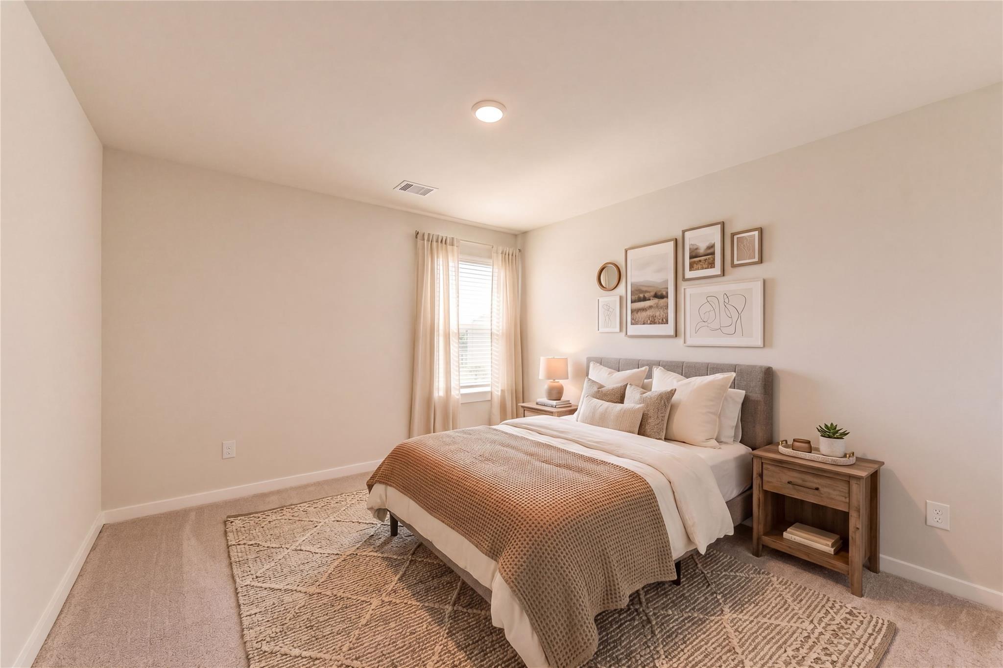 Cozy secondary bedroom with beige walls, upholstered bed, wooden nightstand, and gallery art in Davidson Homes The Sabine F, Dayton, Texas