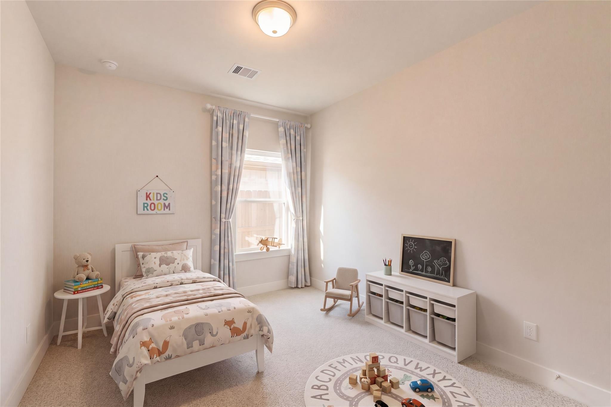 Cozy kids' bedroom with elephant fox bedding, ABC play rug, chalkboard in Davidson Homes The Luna L, Sunterra, Katy, Texas