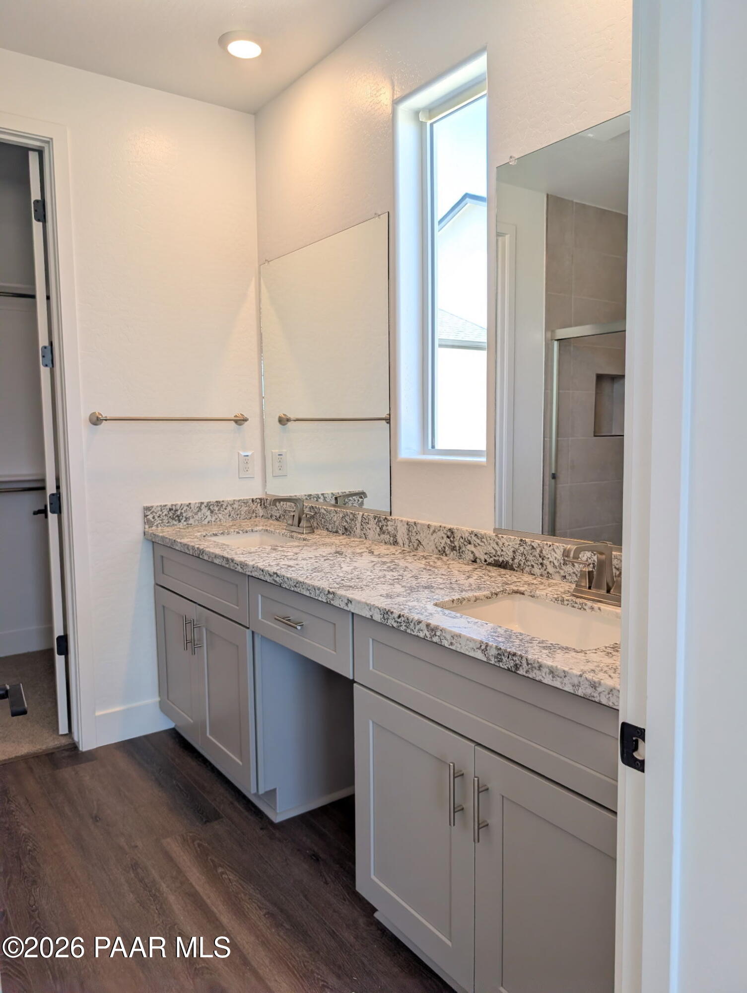 Modern bathroom with dual vanity, granite countertops, and grey cabinets in The Frontier II F home in Prescott, Arizona.