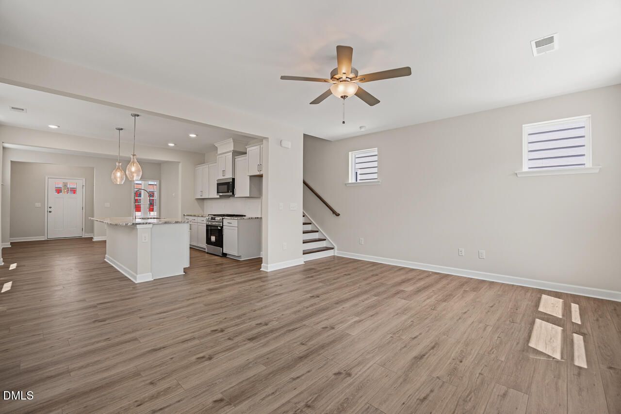 Open-concept living room and kitchen in The Alexander C floor plan at Forestville Yard, Knightdale, North Carolina.