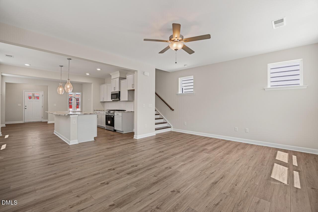 Open-concept living room and kitchen in The Alexander C floor plan at Forestville Yard, Knightdale, North Carolina.