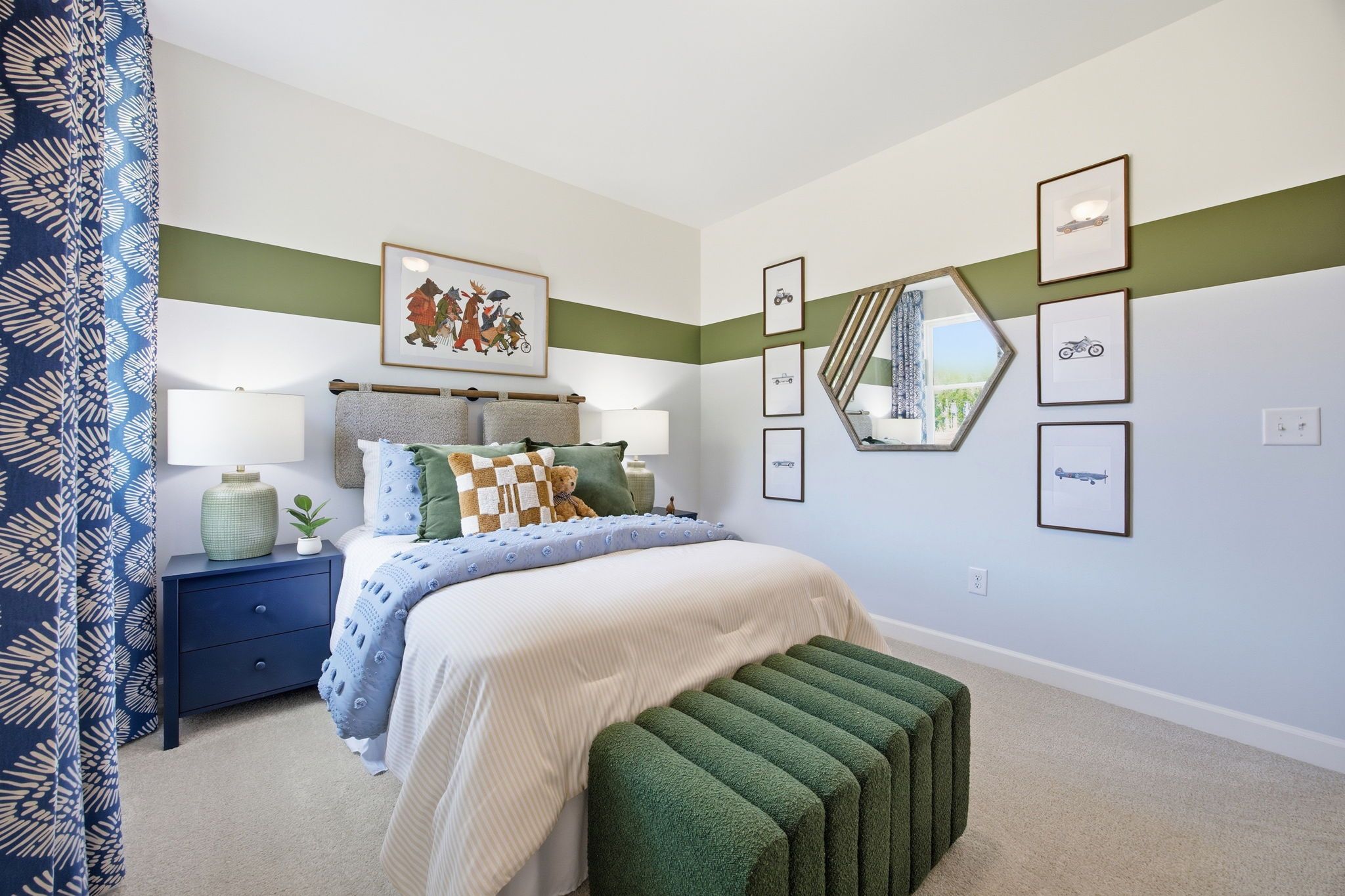 Playful kids' bedroom at Sage on North Main in Wake Forest NC with blue bedding, green accents, and vehicle art