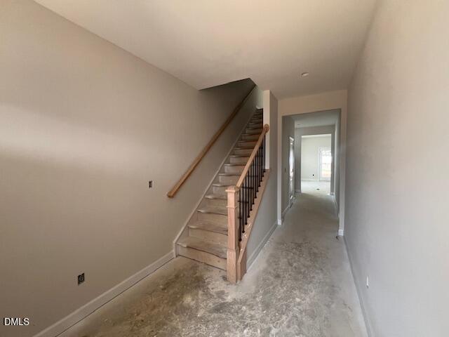Elegant wooden staircase in beige hallway with open layout in 4-bedroom The Preston A home, Lillington, NC