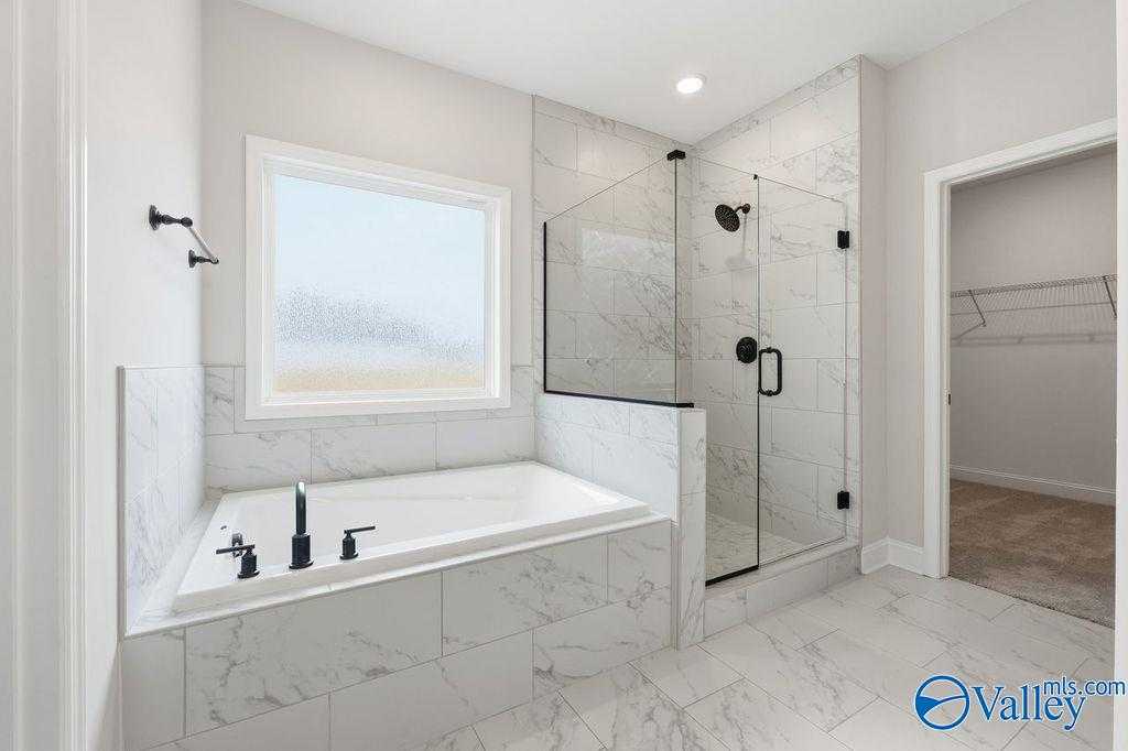Modern master bathroom with freestanding tub, glass shower, subway tile in Davidson Homes The Rockford B, Hartselle, Alabama