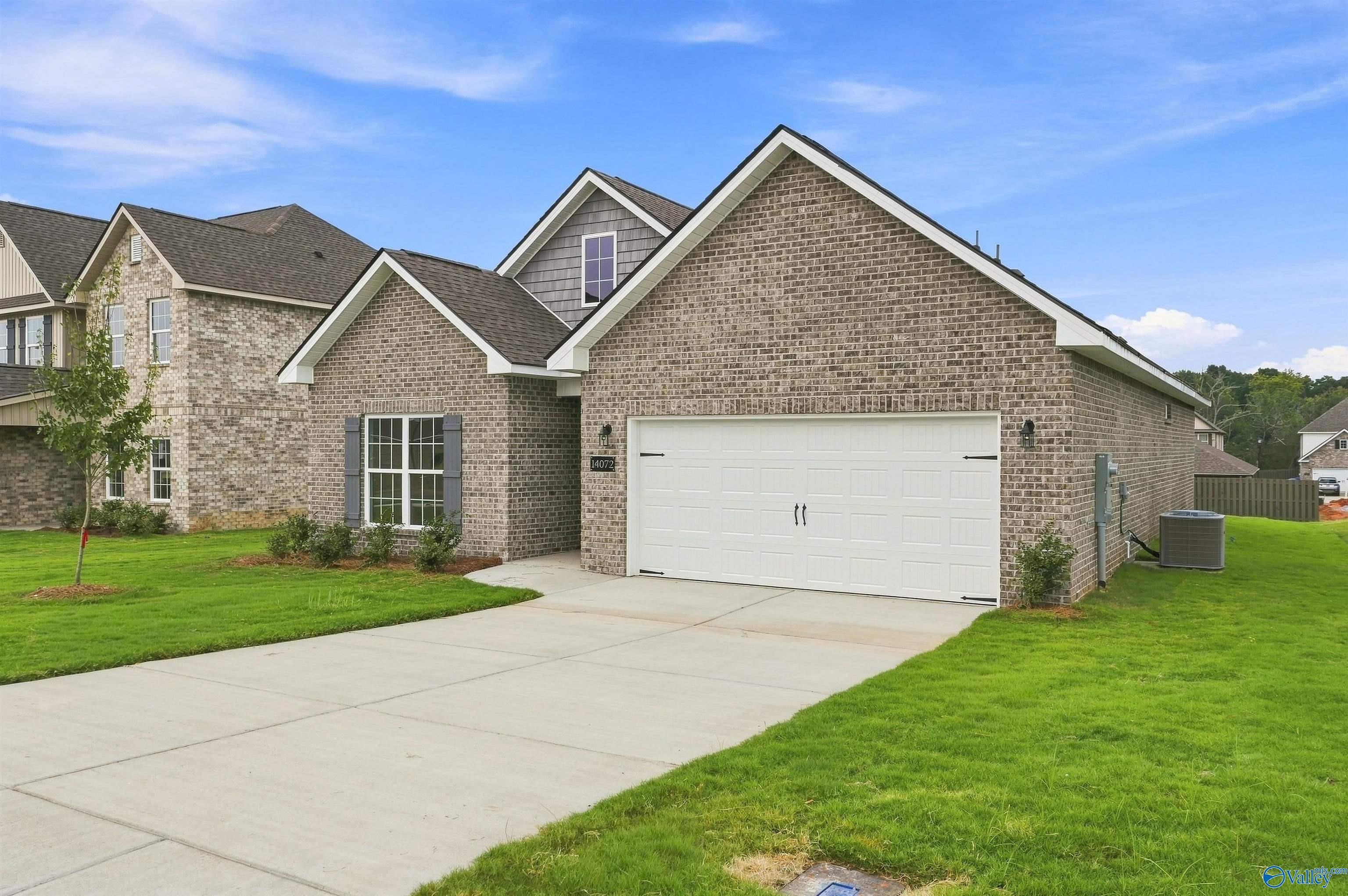 Brick front exterior with 2-car garage and landscaped yard at The Franklin C, a 3-bed Davidson Homes plan in Athens, Alabama