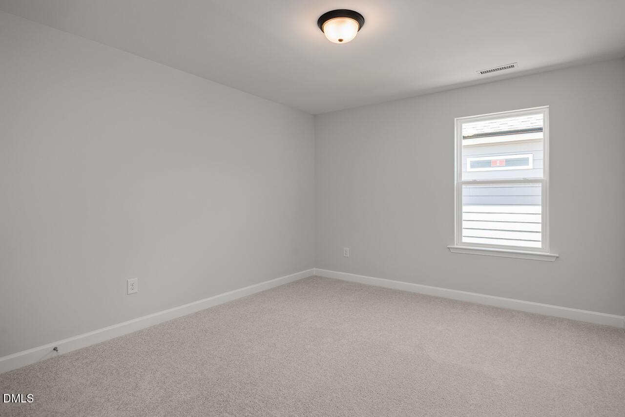Bright, neutral-toned bedroom in The Birch II E floor plan at Sage on North Main in Wake Forest, North Carolina.