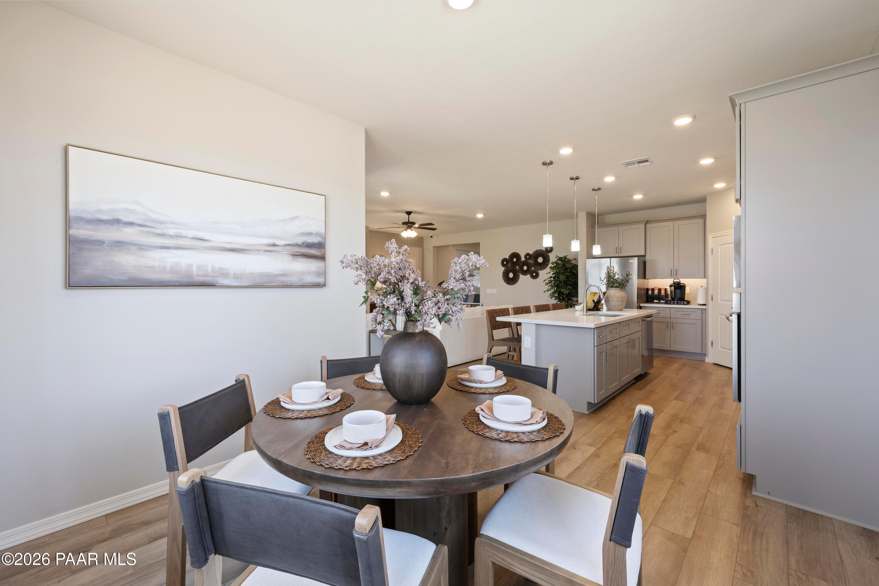 Open-concept dining area and modern kitchen in The Harmony A floor plan at North Ridge, Pronghorn Ranch, Prescott Valley.