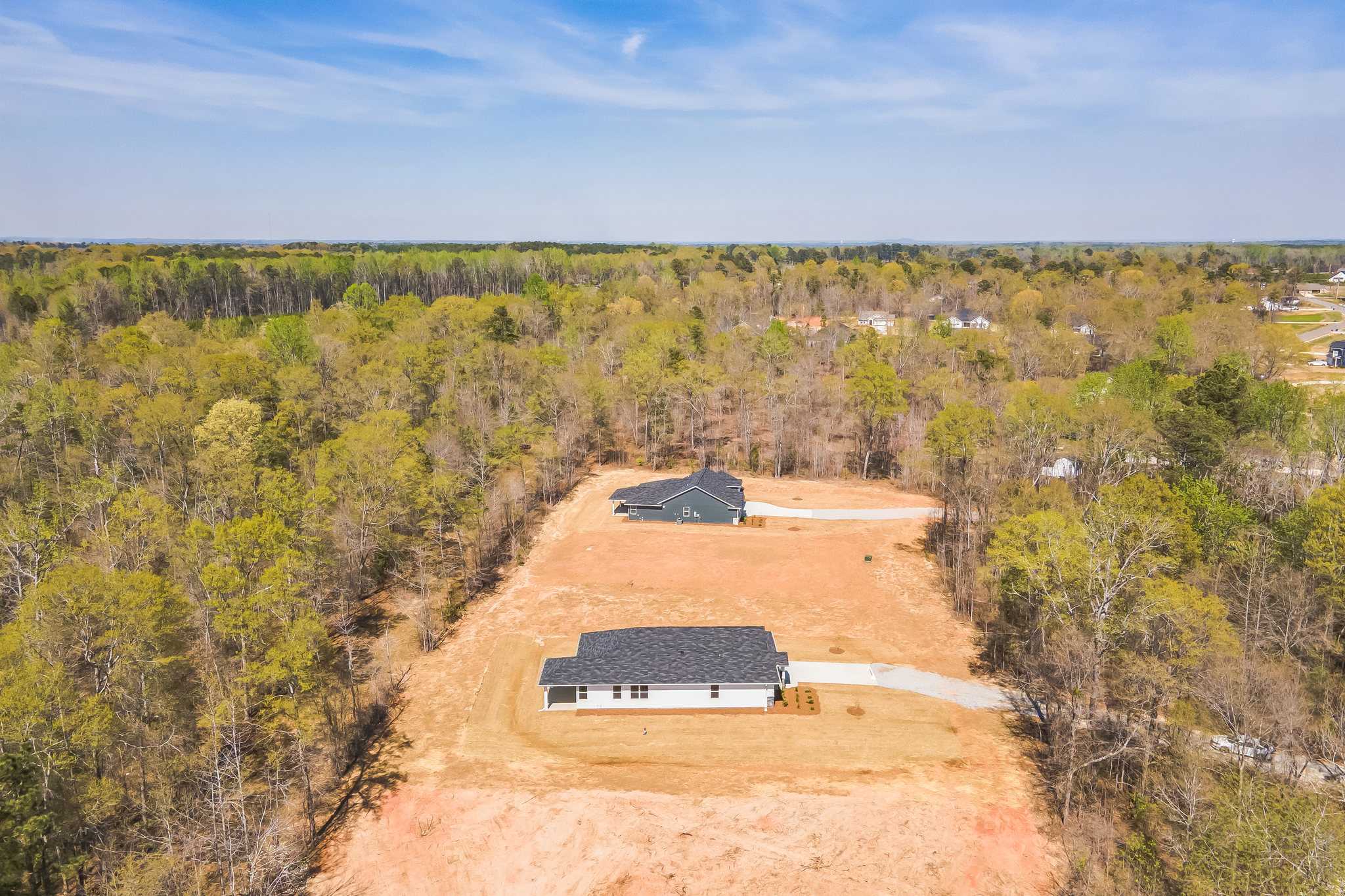 Aerial view of new homes in Silver Oak community, Cusseta Alabama by Evermore Homes amid lush forested landscape